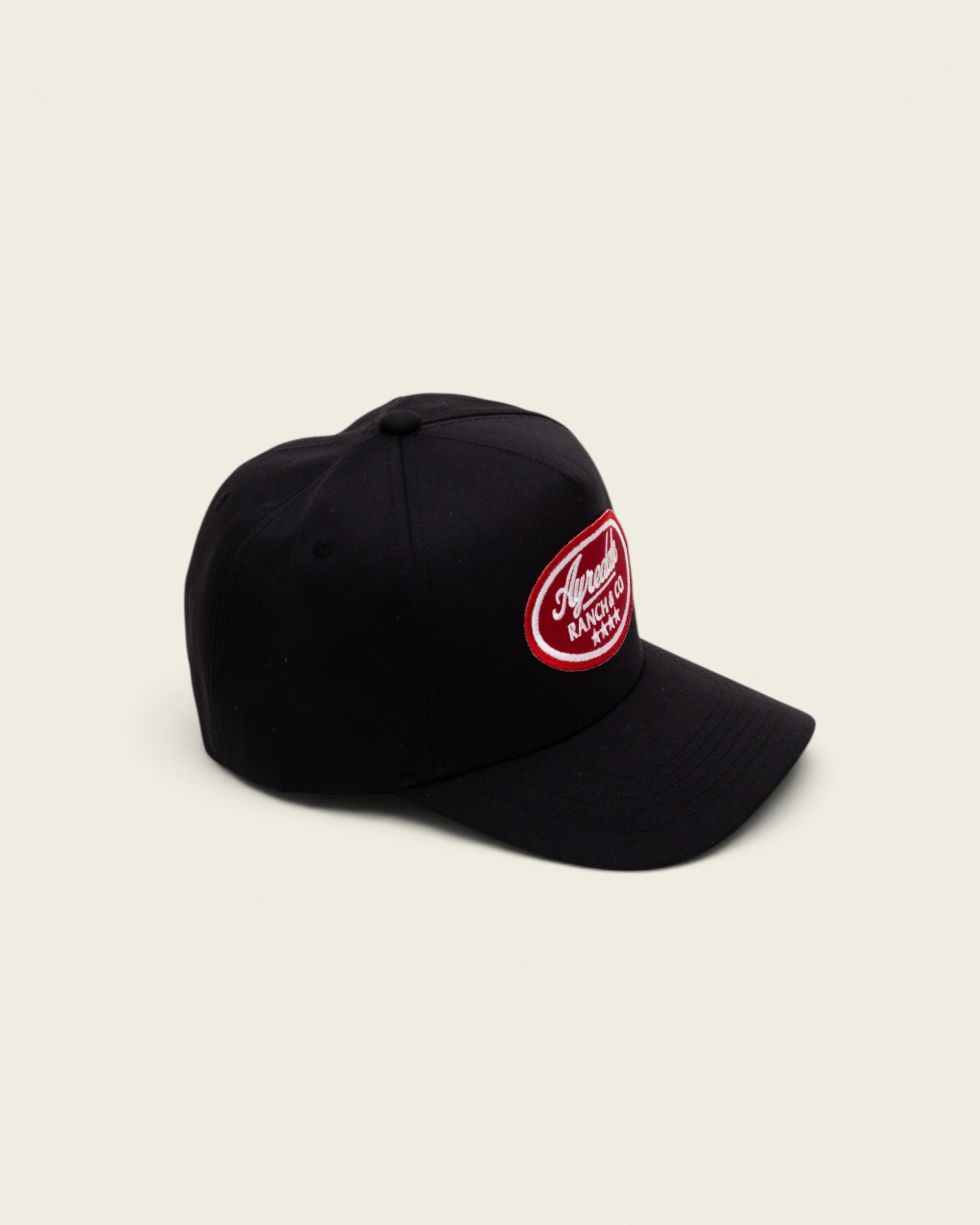 Ayredale Ranch & Co black baseball cap featuring a red oval patch with white logo embroidery and four stars