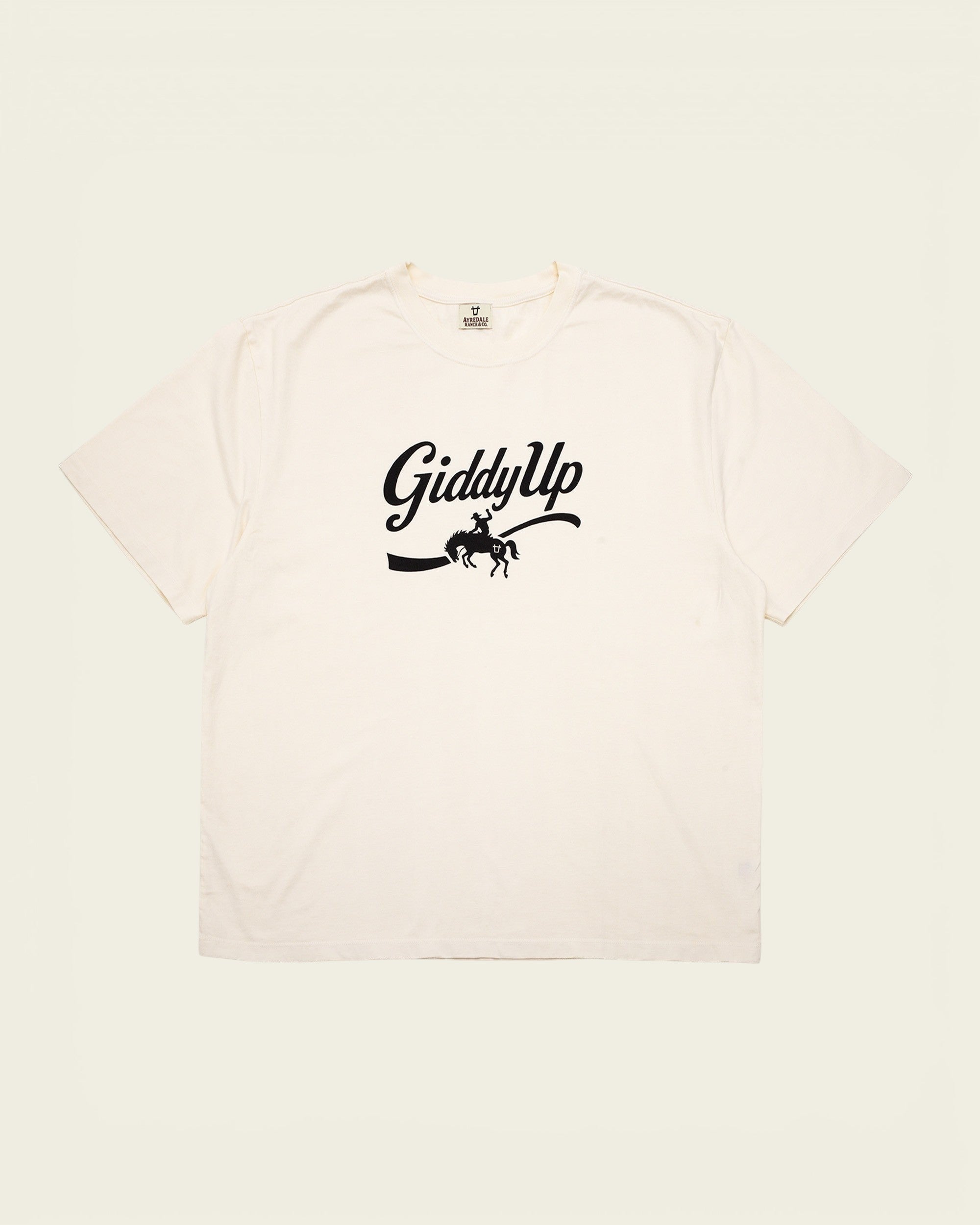 Ayredale Ranch & Co cream short-sleeve t-shirt with black GiddyUp graphic featuring a bucking bronco cowboy design.