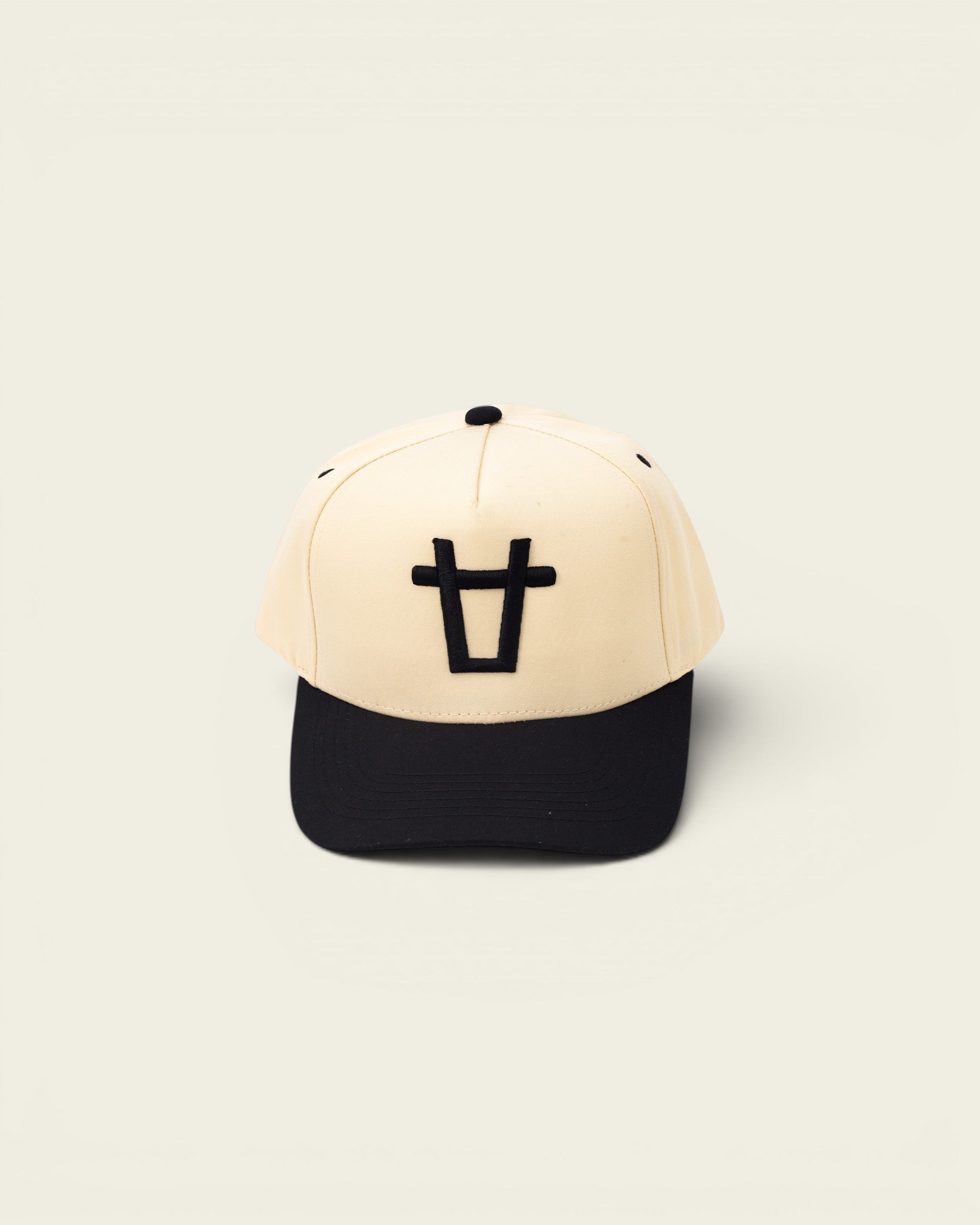 Ayredale Ranch & Co black bull baseball cap with beige crown and black brim, featuring a black bull logo.