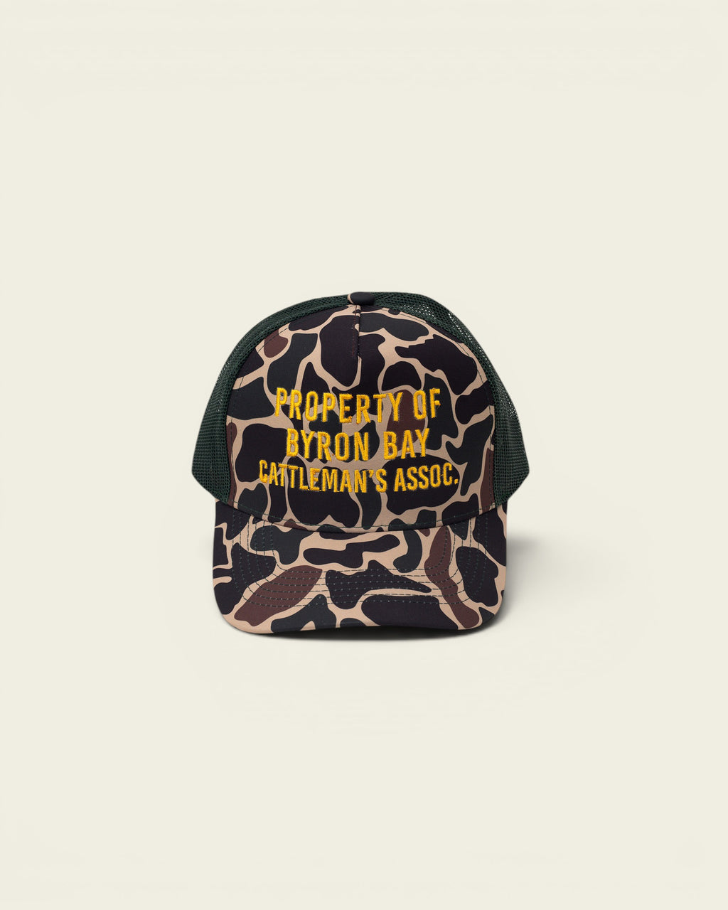 Ayredale Ranch & Co camouflage trucker hat with green mesh back and yellow embroidered text "PROPERTY OF BYRON BAY CATTLEMAN'S ASSOC."