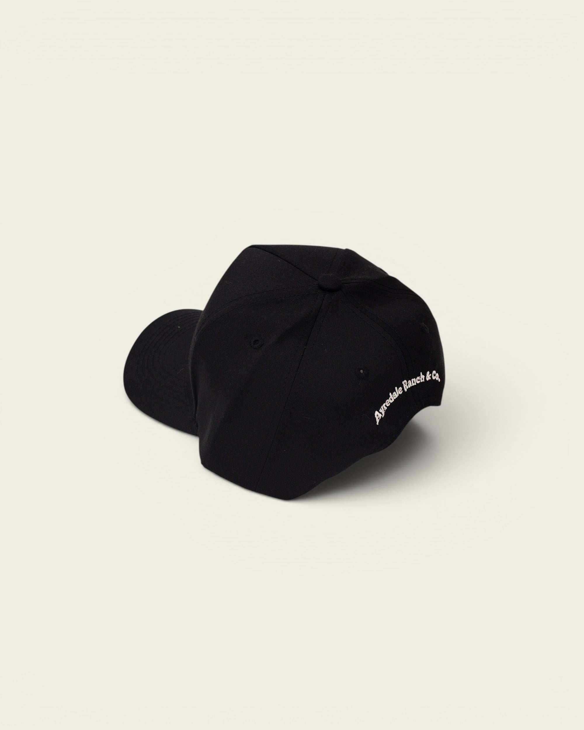 Ayredale Ranch & Co black baseball cap with embroidered logo on the side.