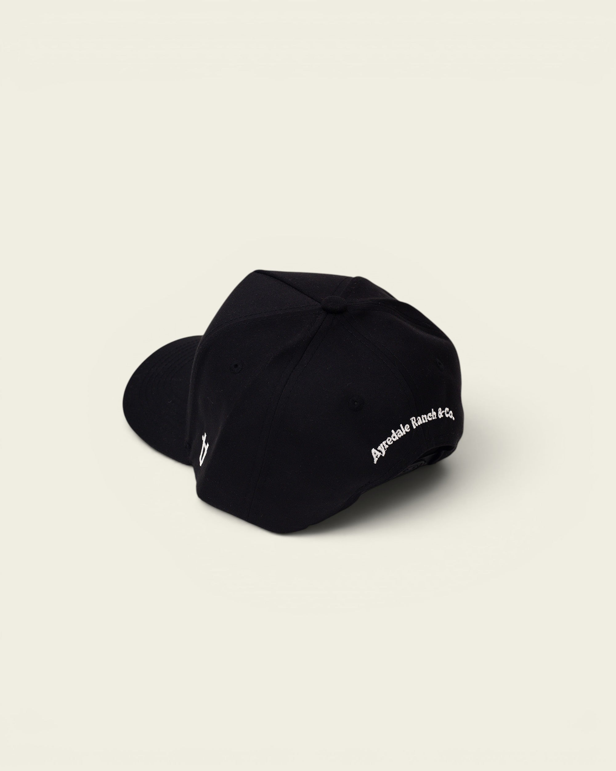 Ayredale Ranch & Co black baseball cap with embroidered logo on the side and text on the back.