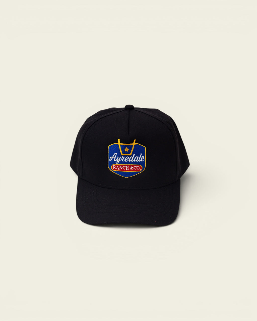 Ayredale Ranch & Co black baseball cap with embroidered shield logo featuring a star and text.