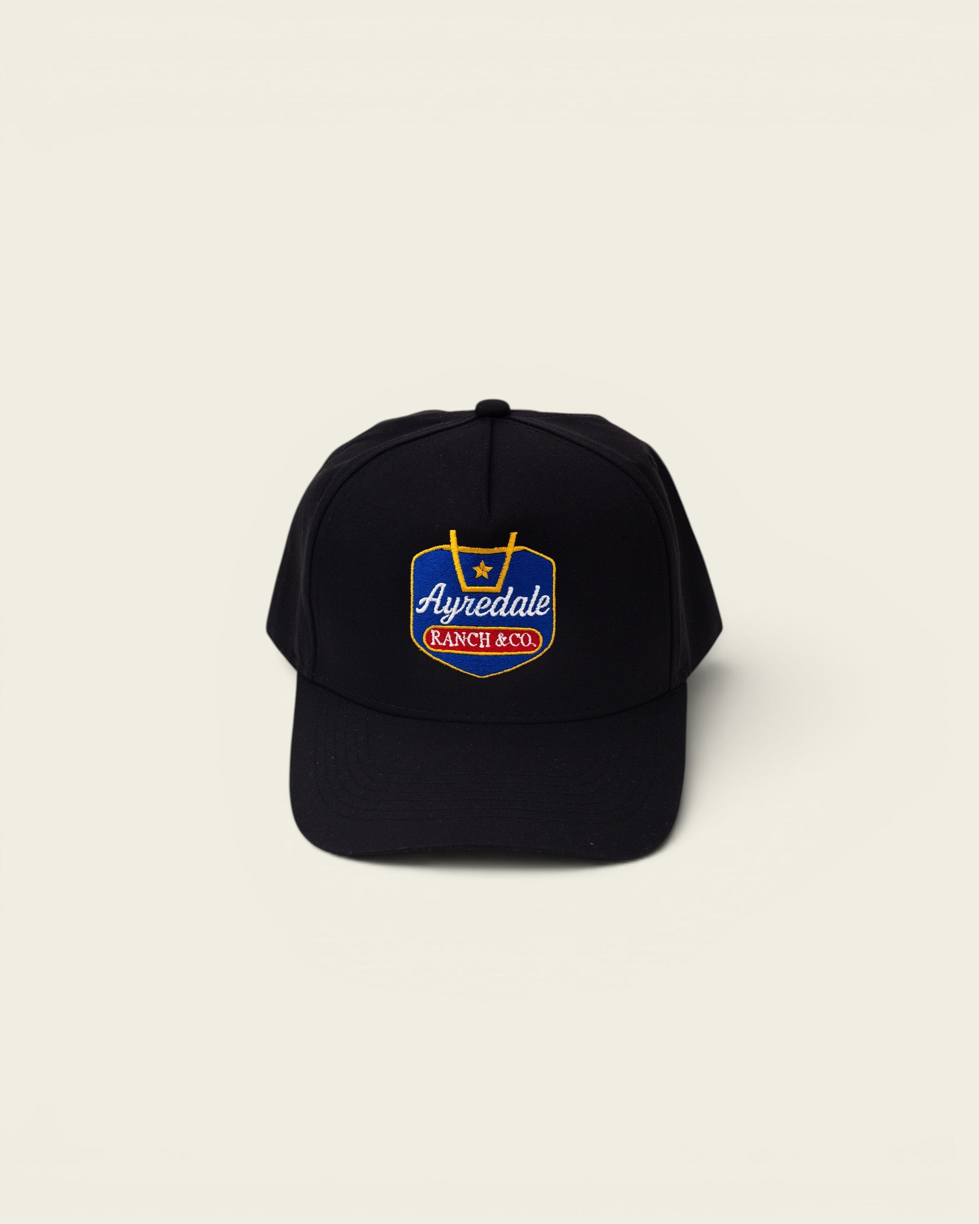 Ayredale Ranch & Co black baseball cap with embroidered shield logo featuring a star and text.