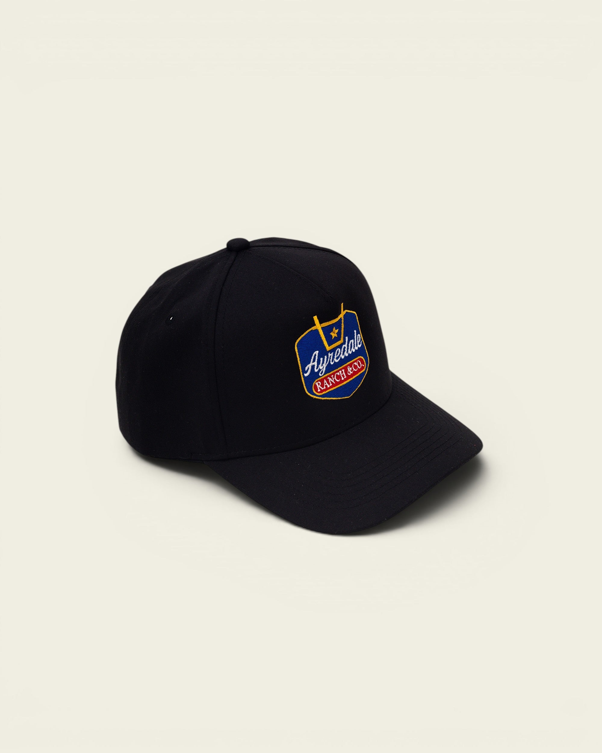 Ayredale Ranch & Co black baseball cap with embroidered shield logo.