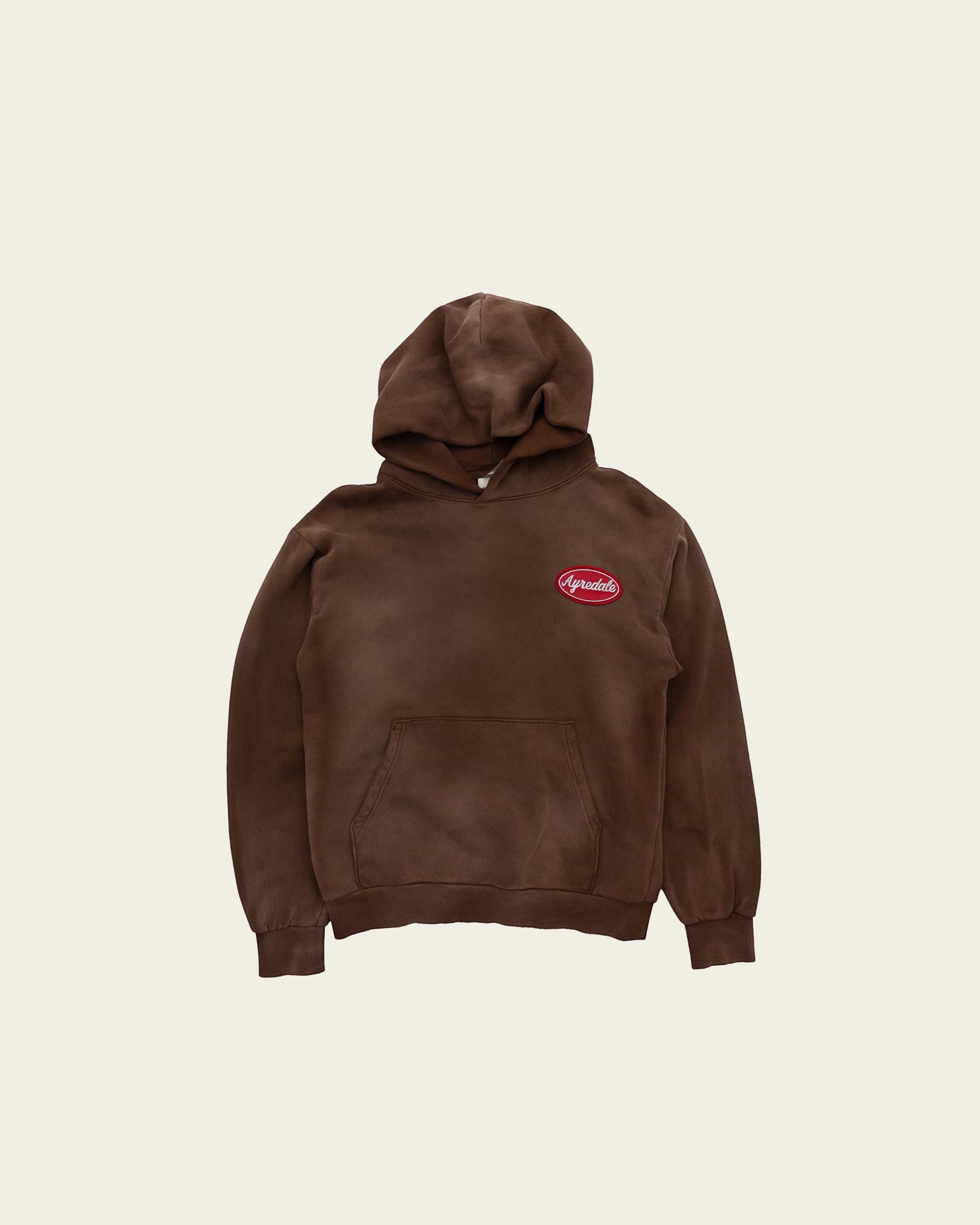 Ayredale Ranch & Co brown Motor Hoodie with a red oval logo patch on the chest and a front kangaroo pocket.