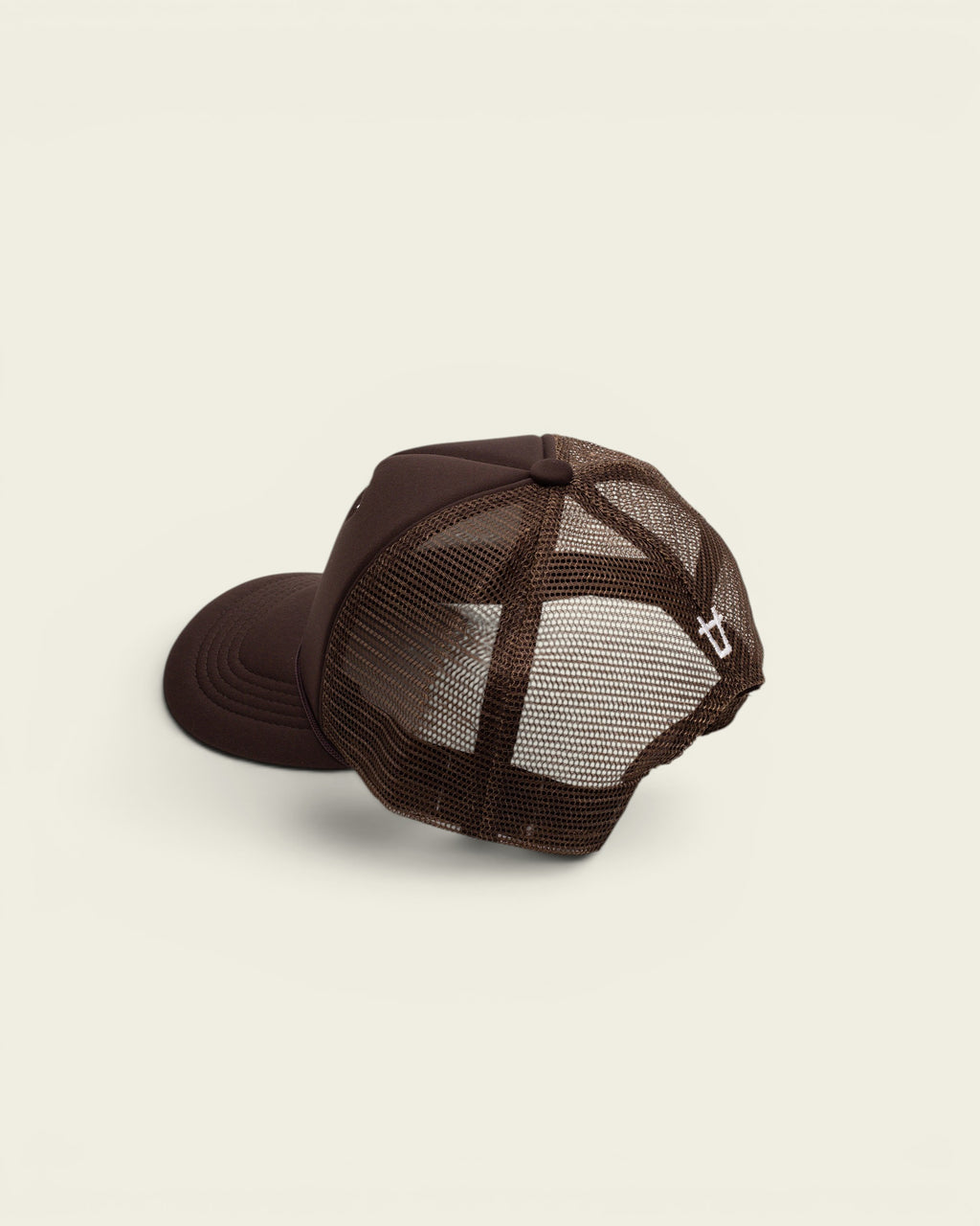 Ayredale Ranch & Co brown trucker hat with breathable mesh back and small white logo embroidery on the side.