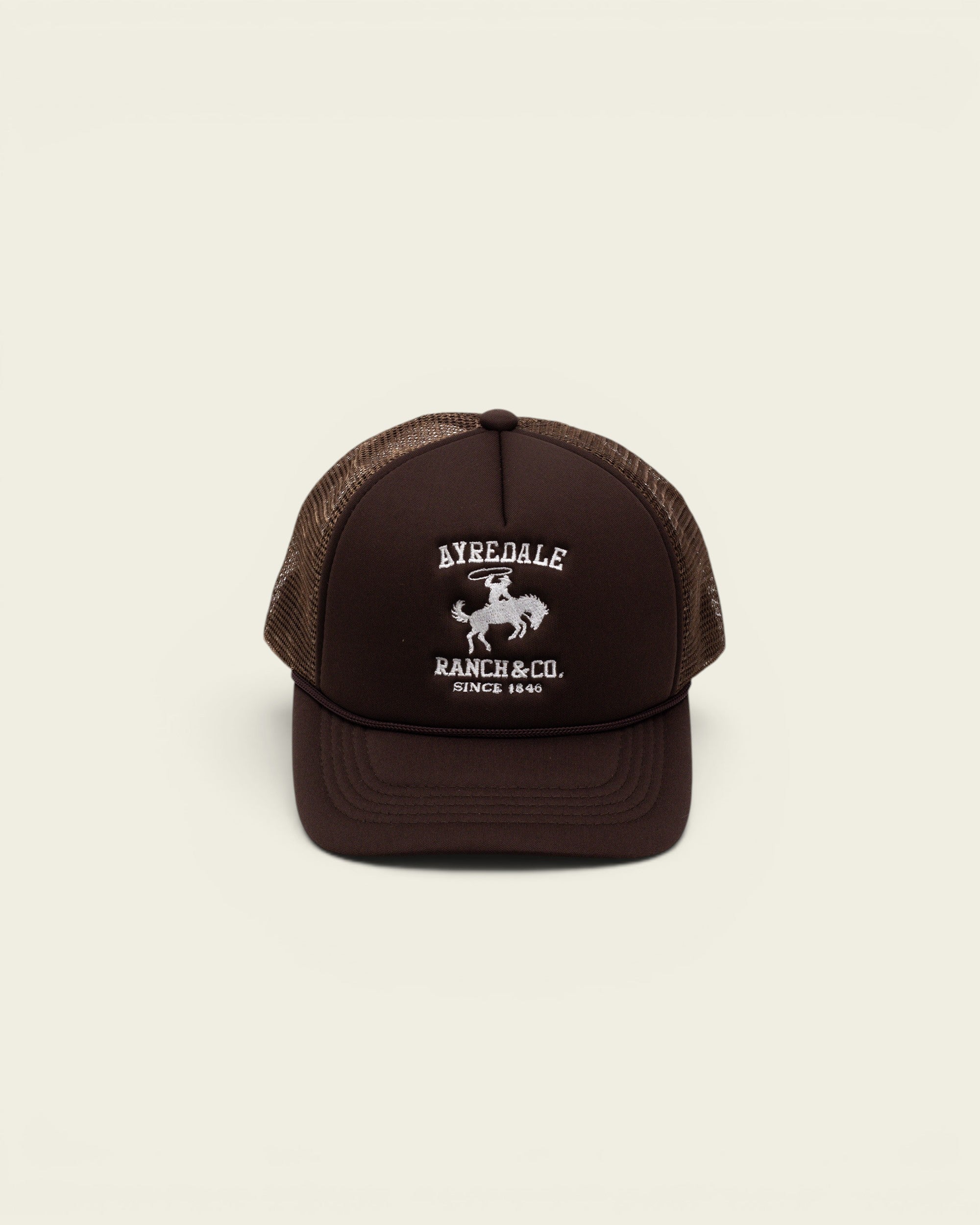 Ayredale Ranch & Co brown trucker hat with white embroidered cowboy logo and mesh back panel