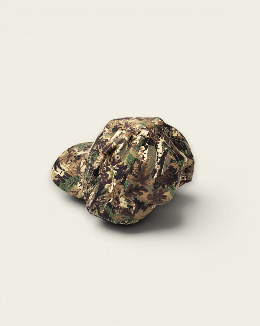 Ayredale Ranch & Co camouflage baseball cap with a curved brim and button detail.