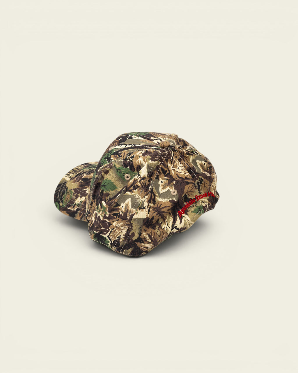 Ayredale Ranch & Co camouflage baseball cap with red embroidered logo on the side.