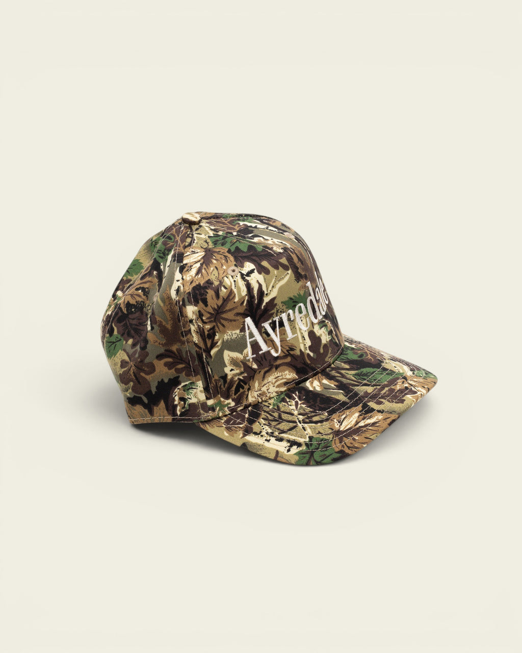 Ayredale Ranch & Co OG snapback cap in camouflage cotton twill with white serif wordmark embroidery.