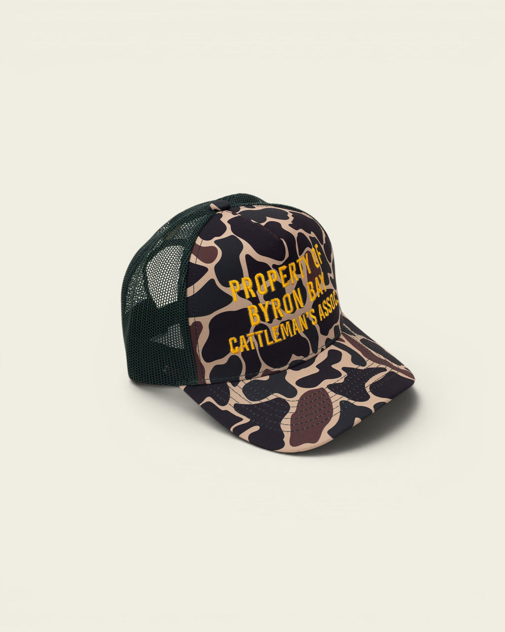 Ayredale Ranch & Co camouflage trucker hat with green mesh back and embroidered text.