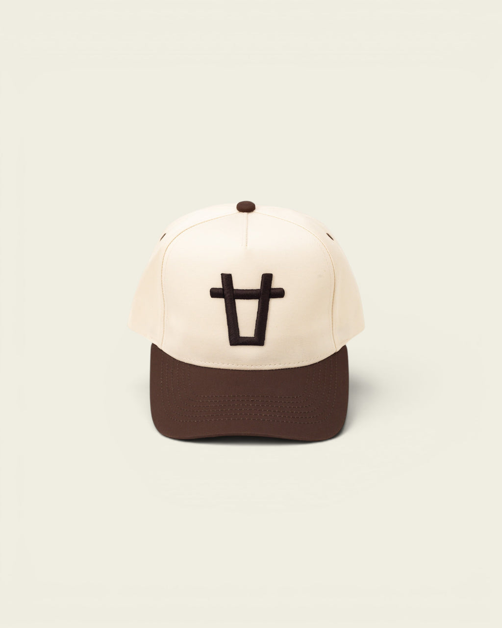 Ayredale Ranch & Co cream baseball cap with brown brim and embroidered black bull logo.