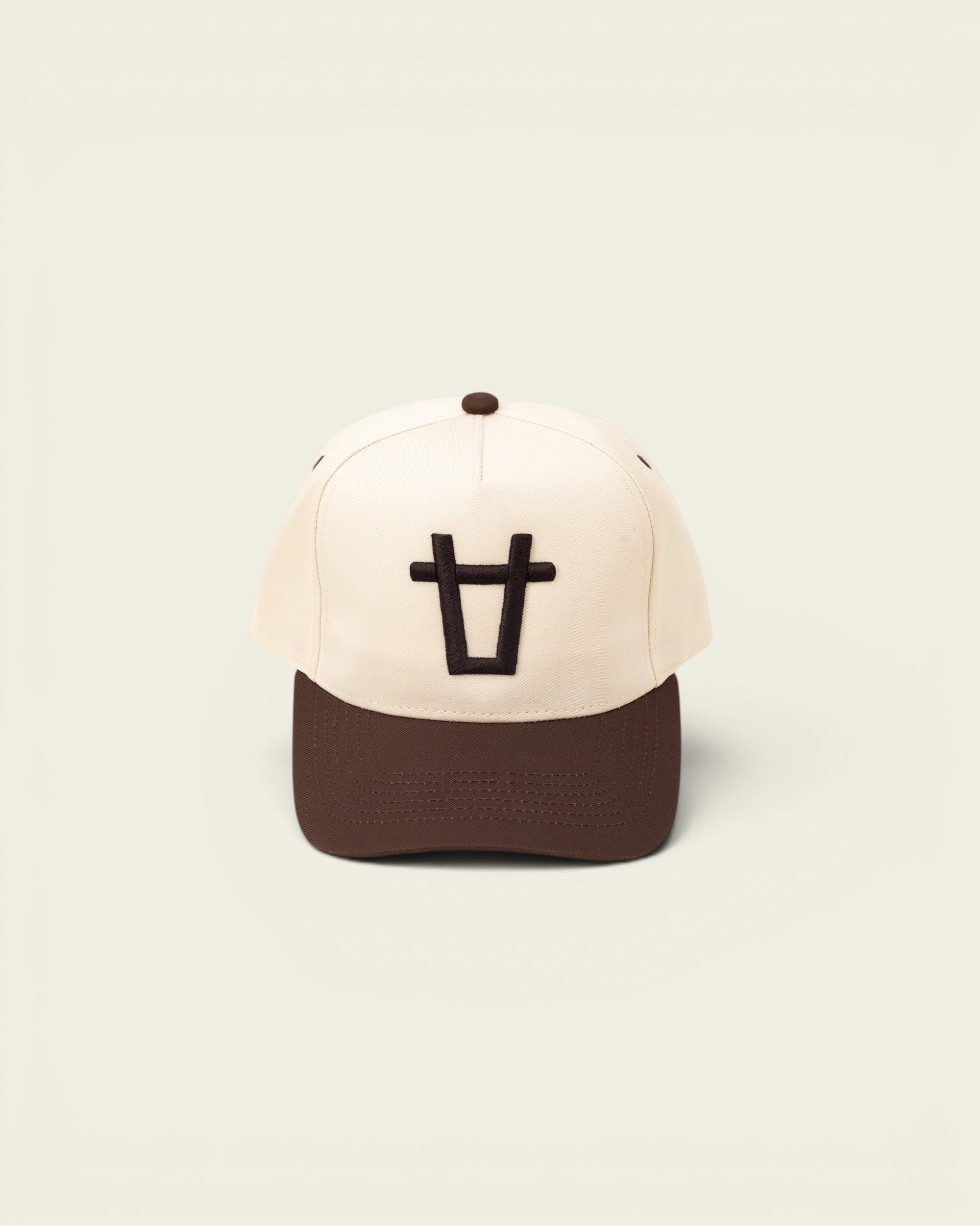 Ayredale Ranch & Co cream baseball cap with brown brim and embroidered black bull logo.