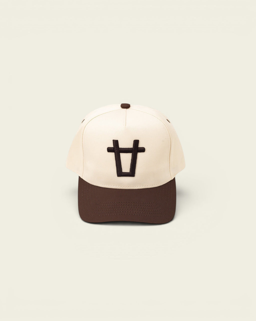 Ayredale Ranch & Co cream baseball cap with brown brim and embroidered black bull logo.