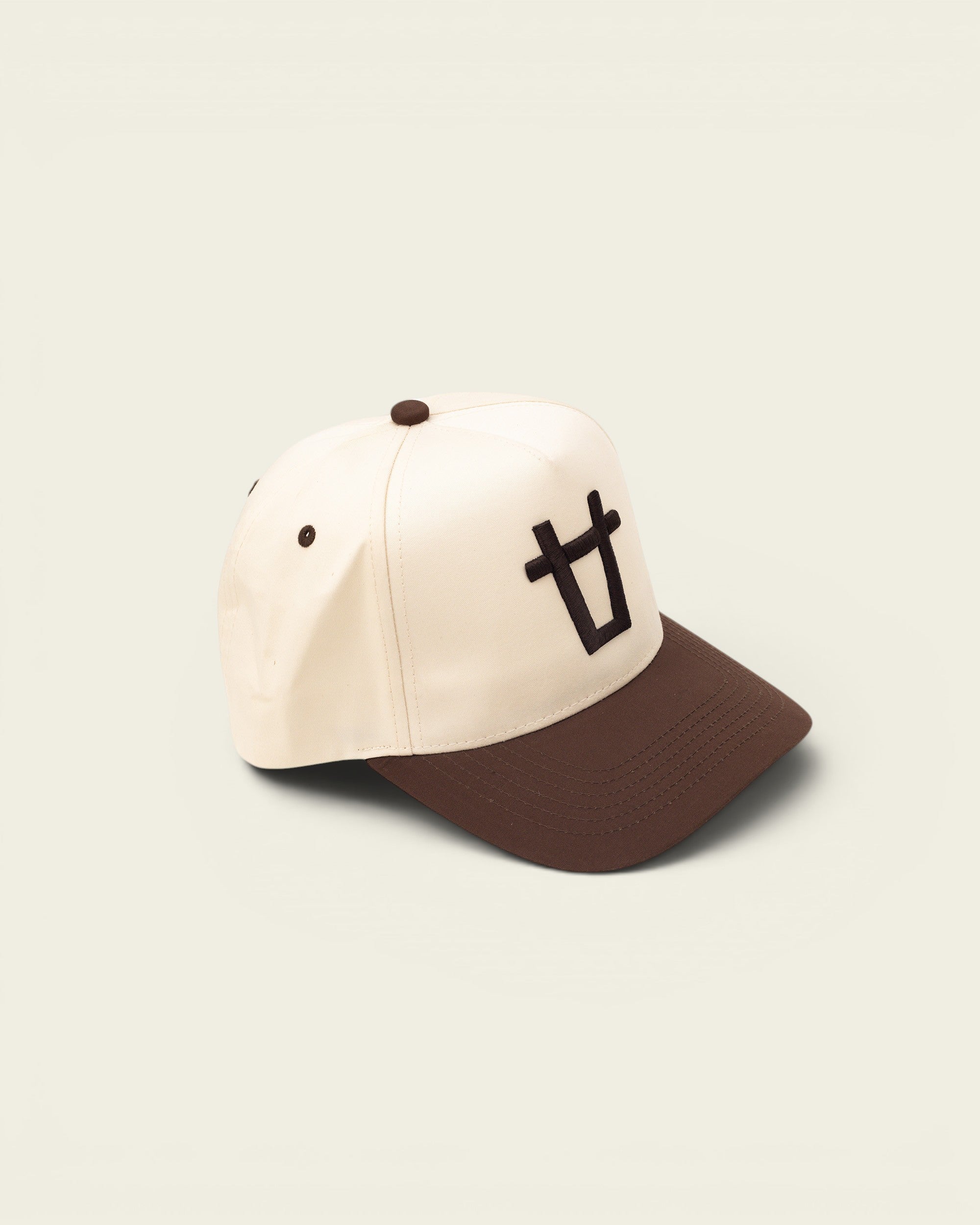 Ayredale Ranch & Co cream baseball cap with brown brim and embroidered bull logo.