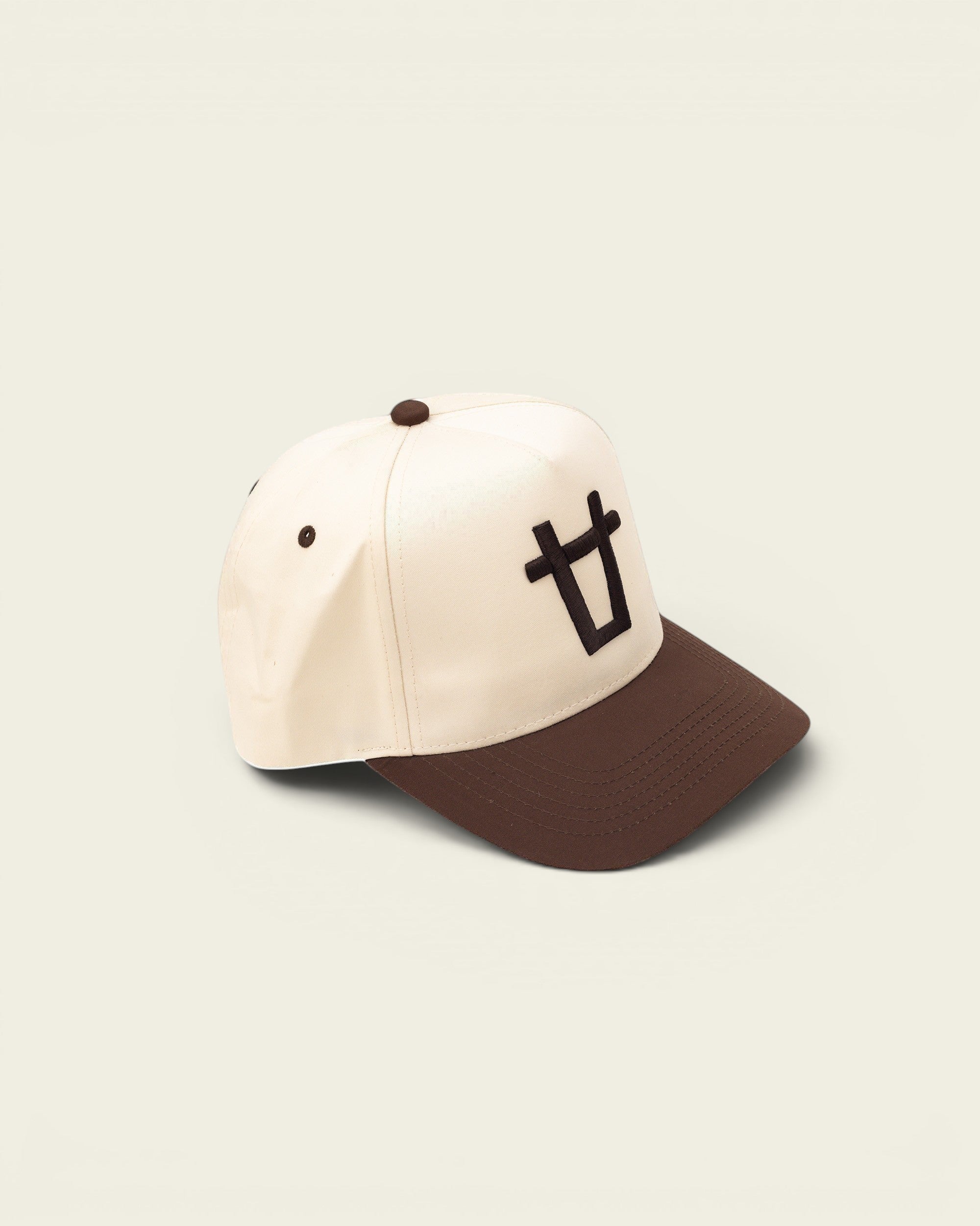 Ayredale Ranch & Co cream baseball cap with brown brim and embroidered bull logo.