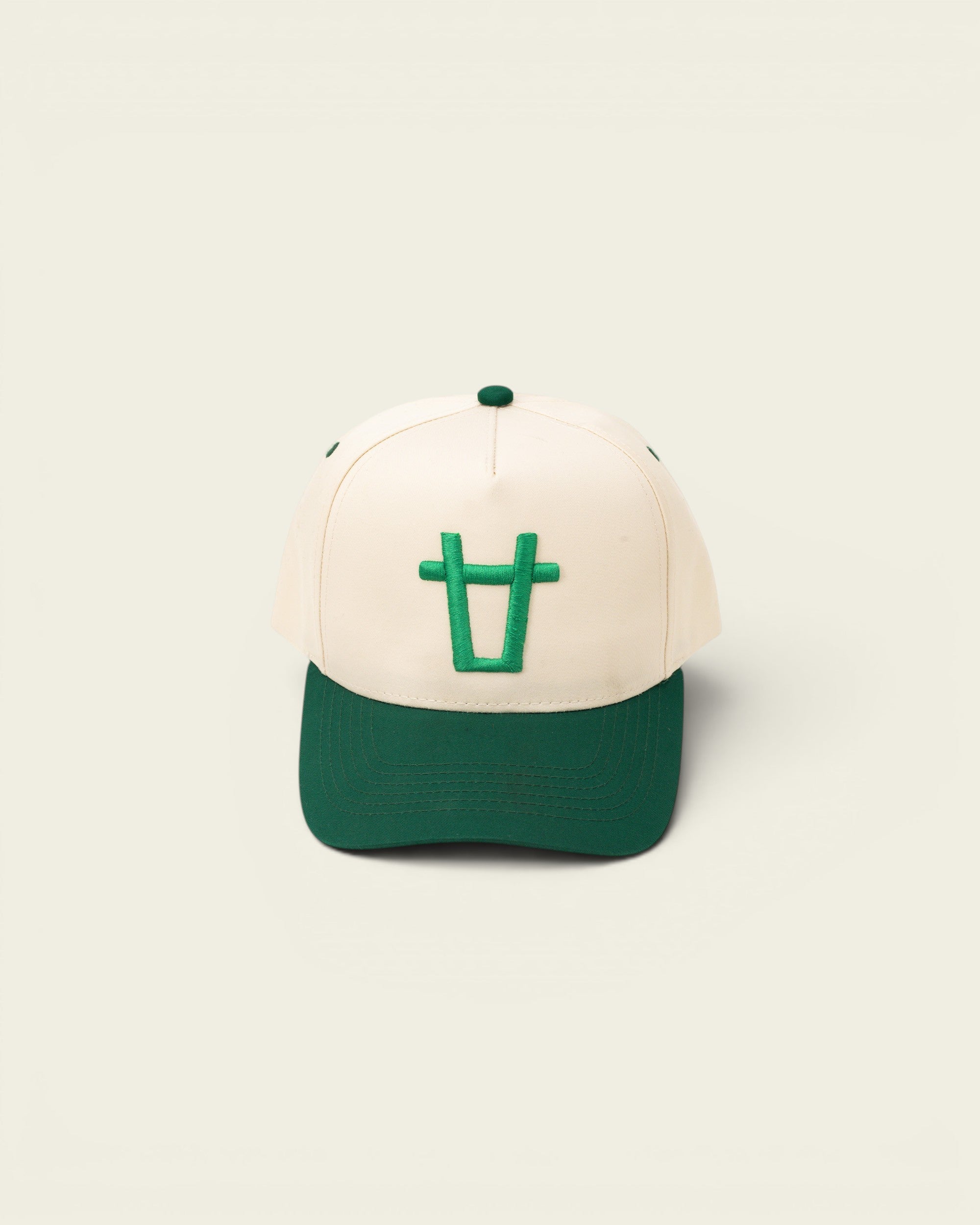 Ayredale Ranch & Co cream baseball cap with green bull logo and green brim.