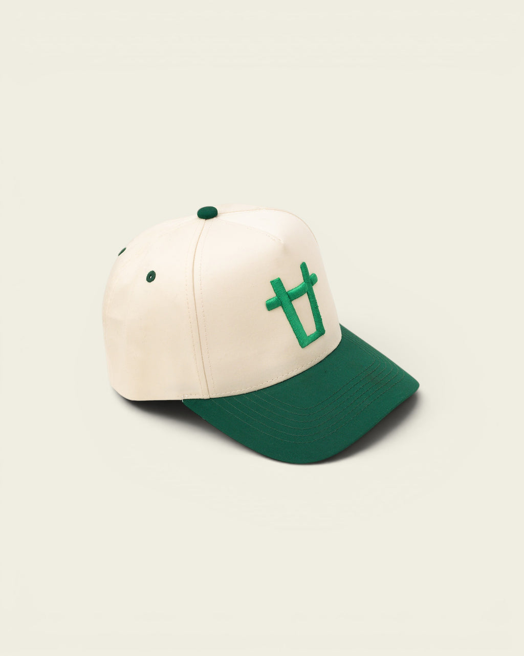 Ayredale Ranch & Co cream baseball cap with green brim and embroidered green bull logo on front.
