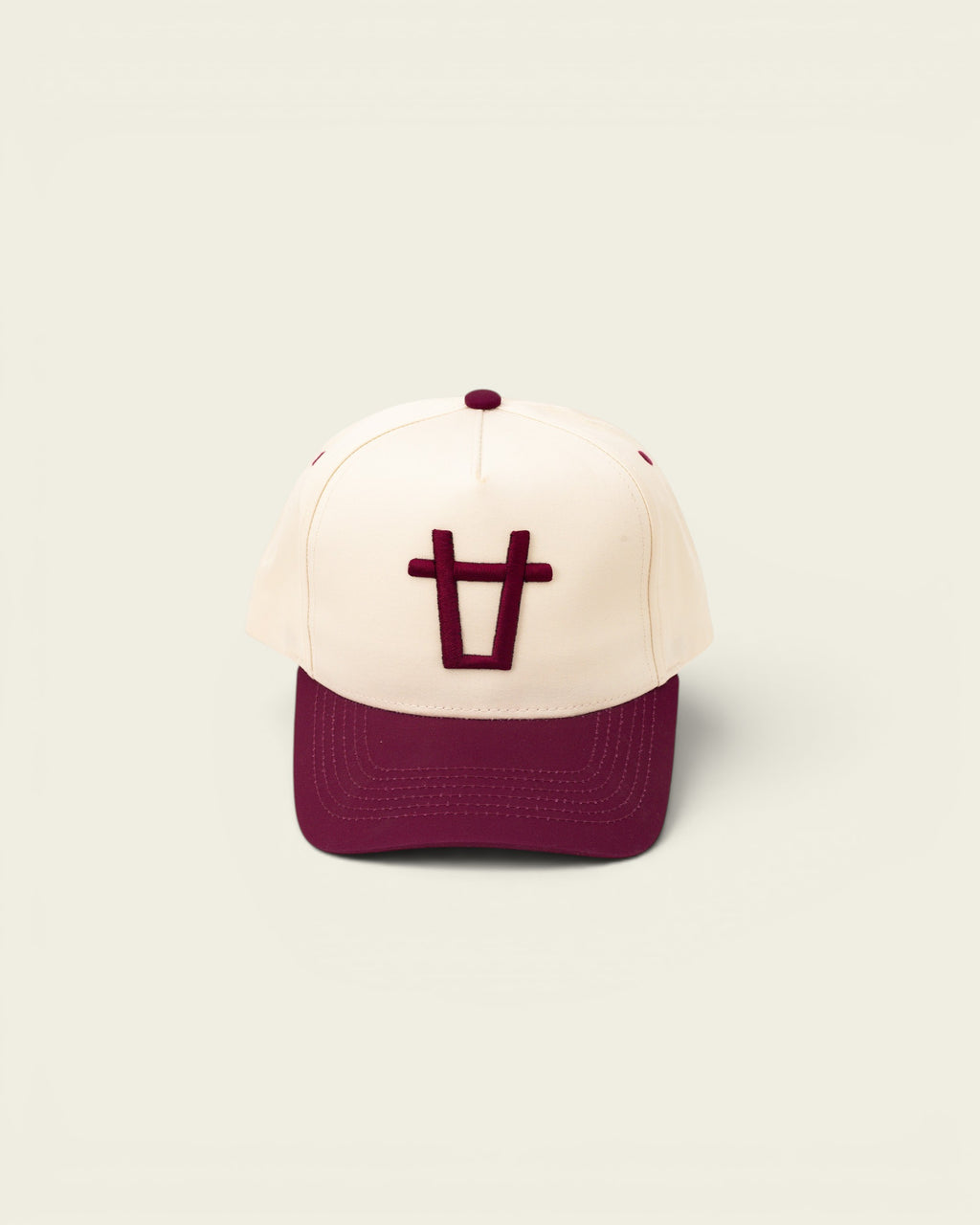 Ayredale Ranch & Co cream baseball cap with maroon brim and embroidered maroon bull logo.