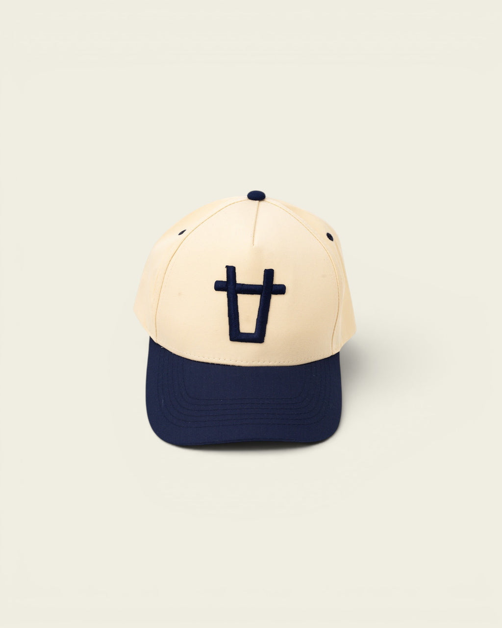 Ayredale Ranch & Co cream baseball cap with navy blue brim and embroidered navy blue logo on the front.