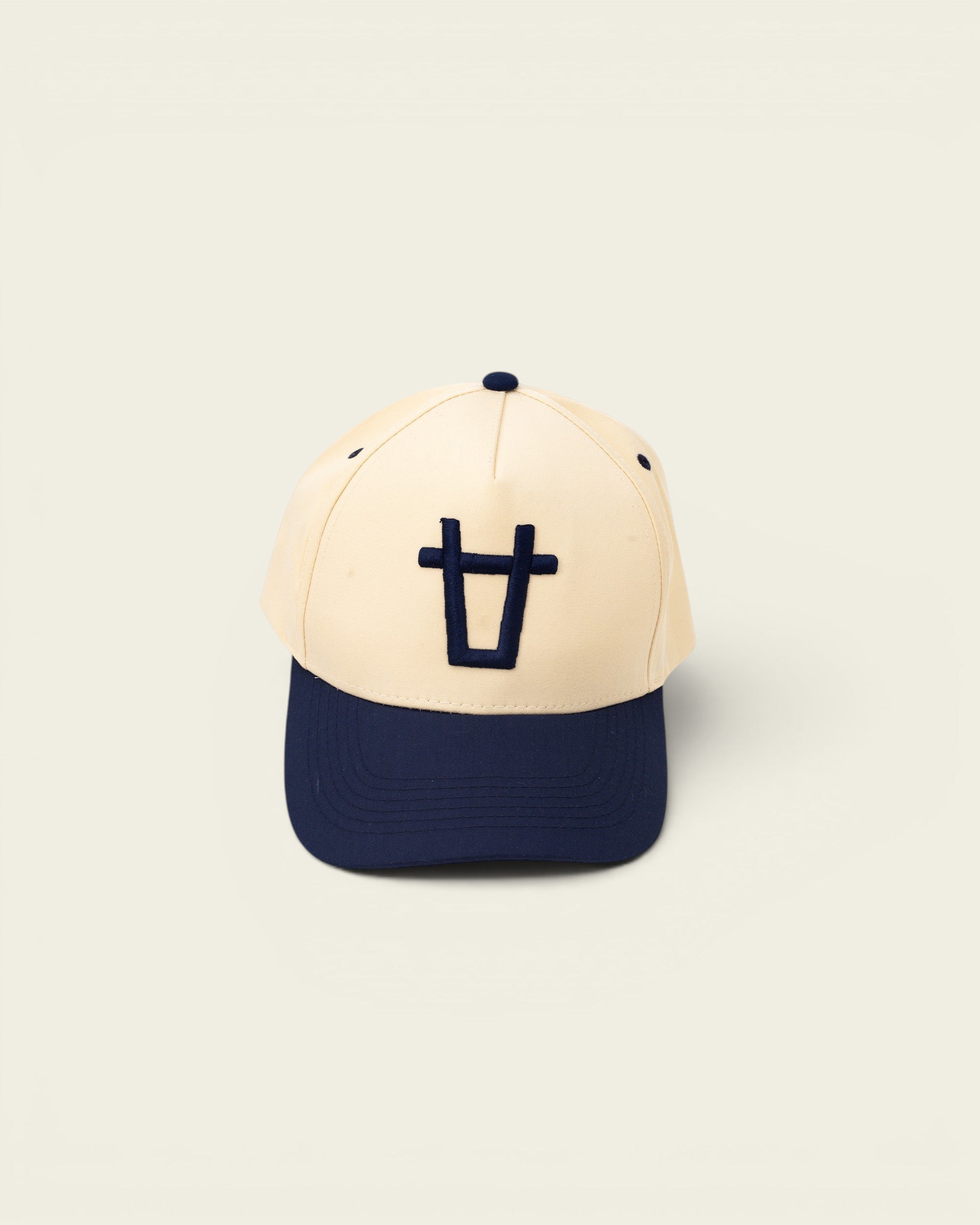 Ayredale Ranch & Co cream baseball cap with navy blue brim and embroidered navy blue logo on the front.