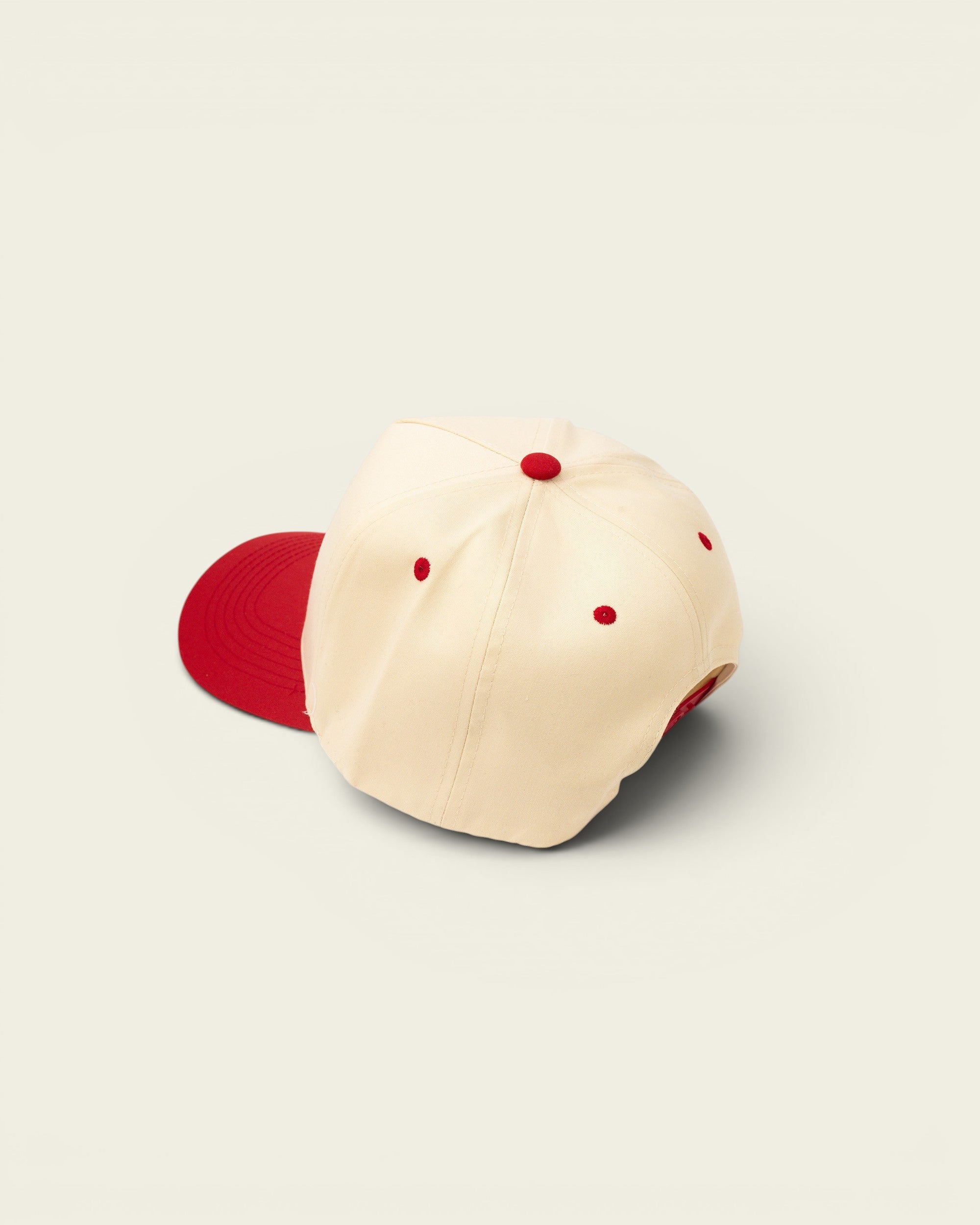 Ayredale Ranch & Co cream baseball cap with red brim and red stitching detail.