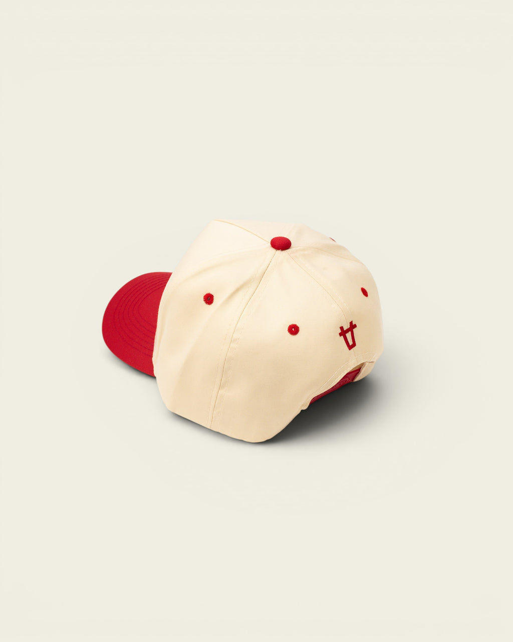 Ayredale Ranch & Co cream baseball cap with red brim and embroidered logo detail.