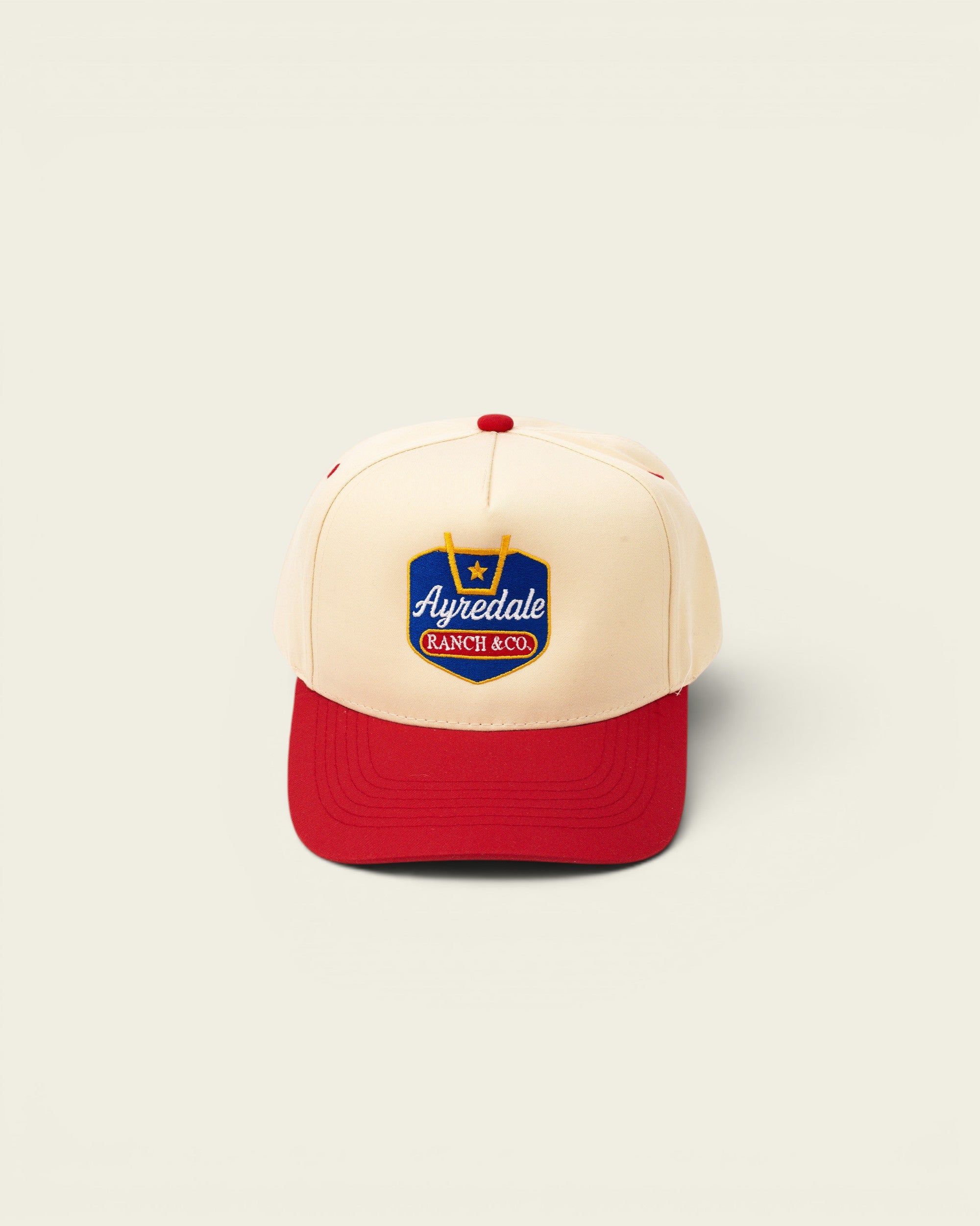 Ayredale Ranch & Co. cream and red trucker hat with embroidered logo
