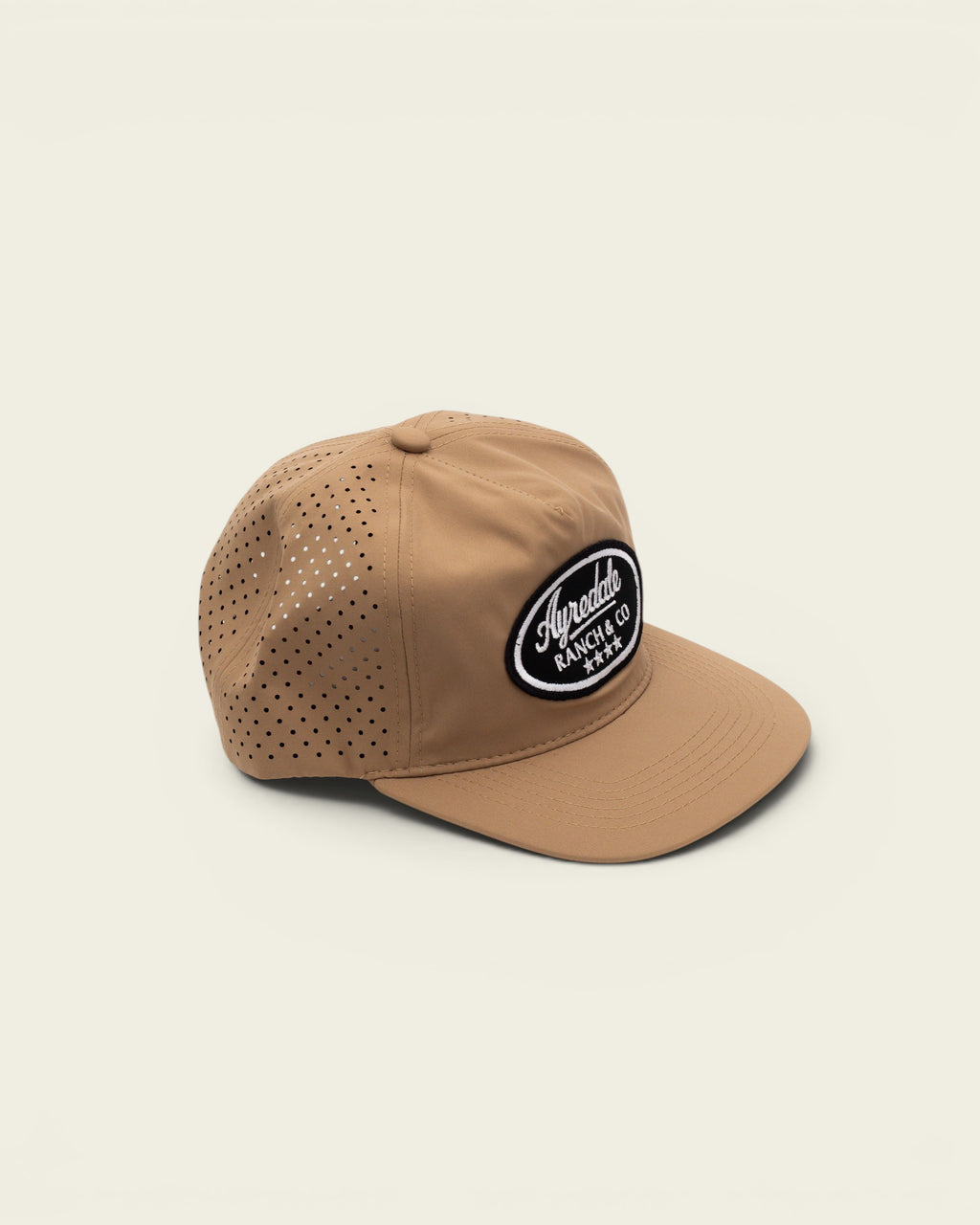 Ayredale Ranch & Co Cream Sport baseball cap with perforated side panels and a black oval brand patch.