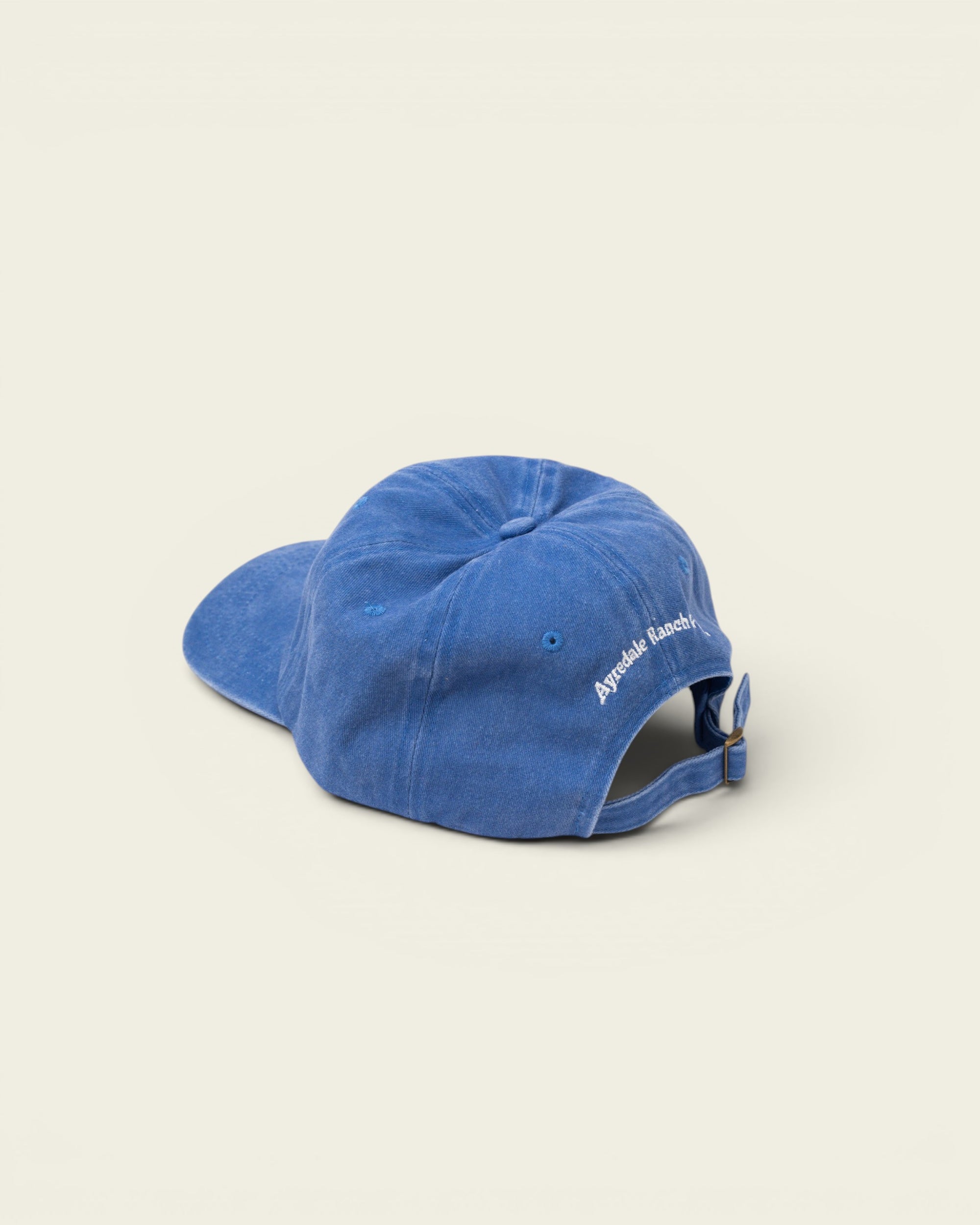 Ayredale Ranch & Co faded blue cotton baseball cap with adjustable strap and embroidered logo.
