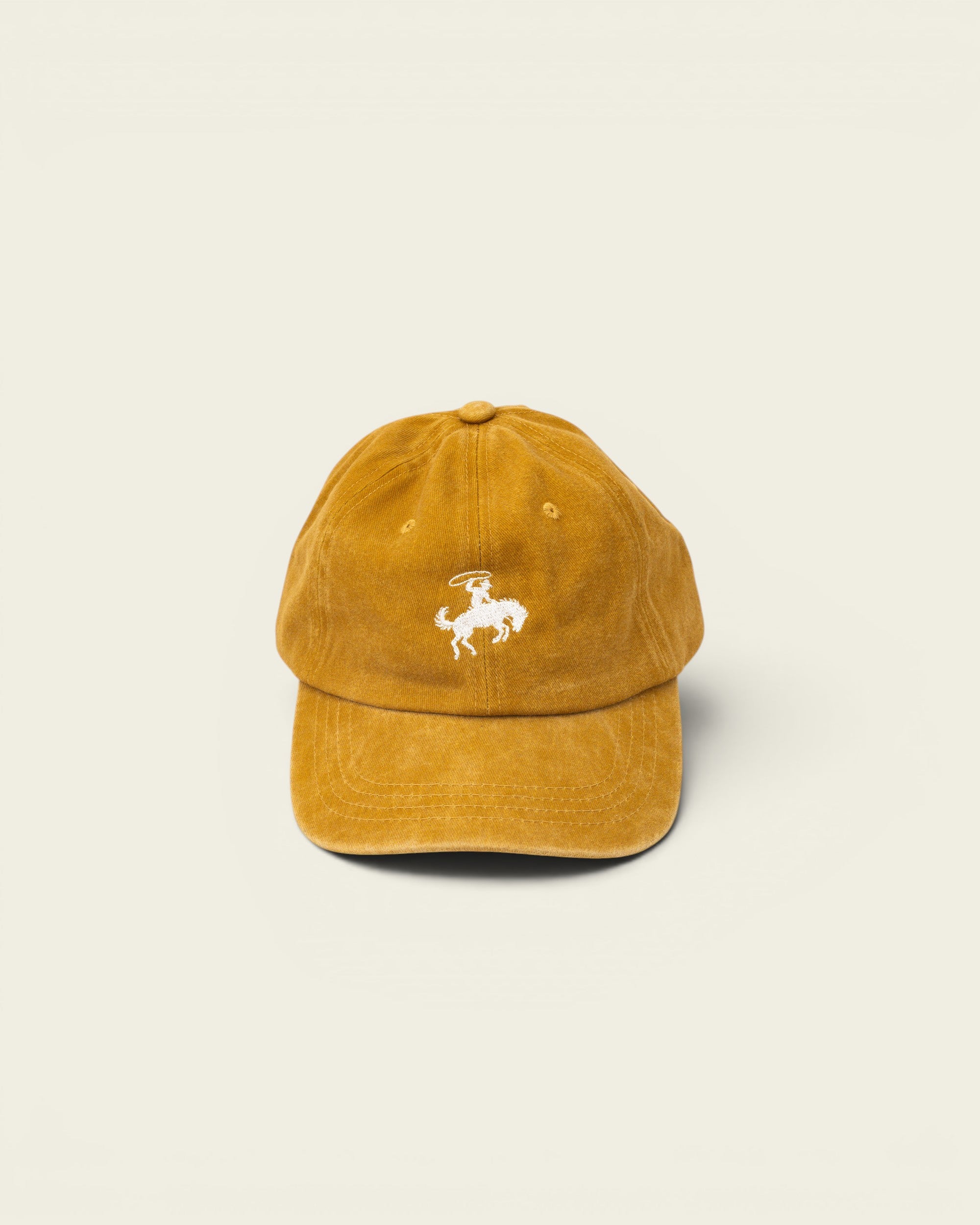 Ayredale Ranch & Co faded yellow baseball cap with embroidered white rodeo rider graphic.