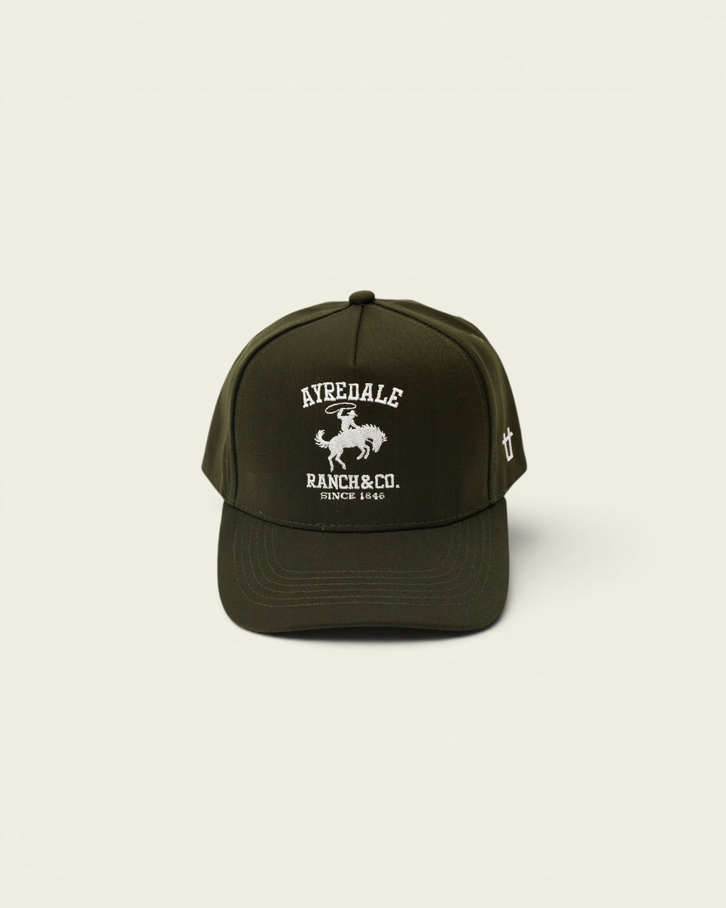 Ayredale Ranch & Co dark green baseball cap with white embroidered logo of a cowboy on a horse.