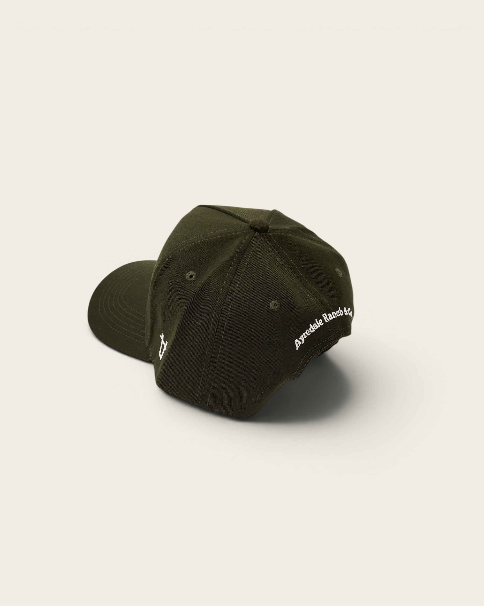 Ayredale Ranch & Co dark green baseball cap with embroidered logo on the side and back.