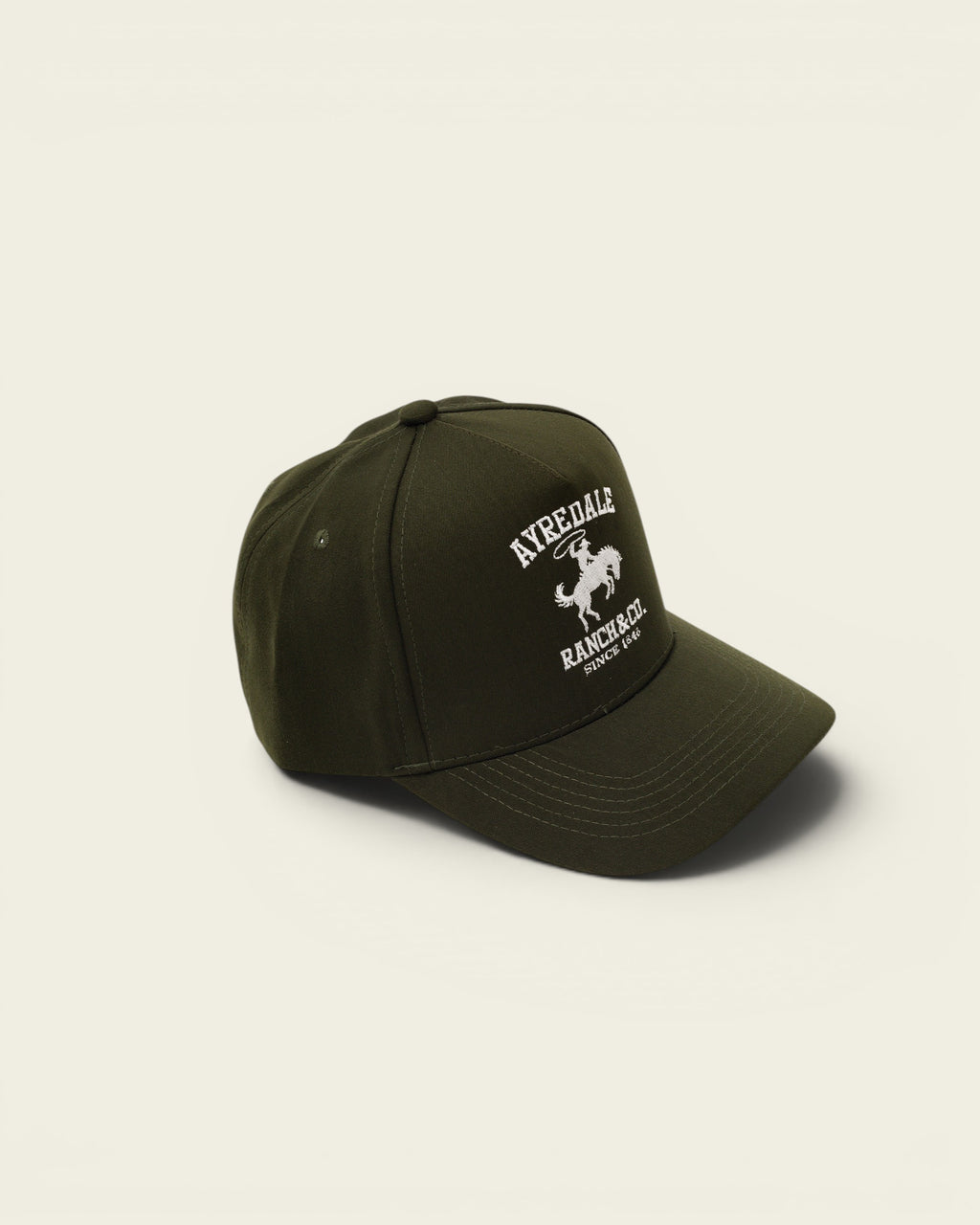Ayredale Ranch & Co dark green baseball cap with embroidered logo featuring a cowboy on a horse.