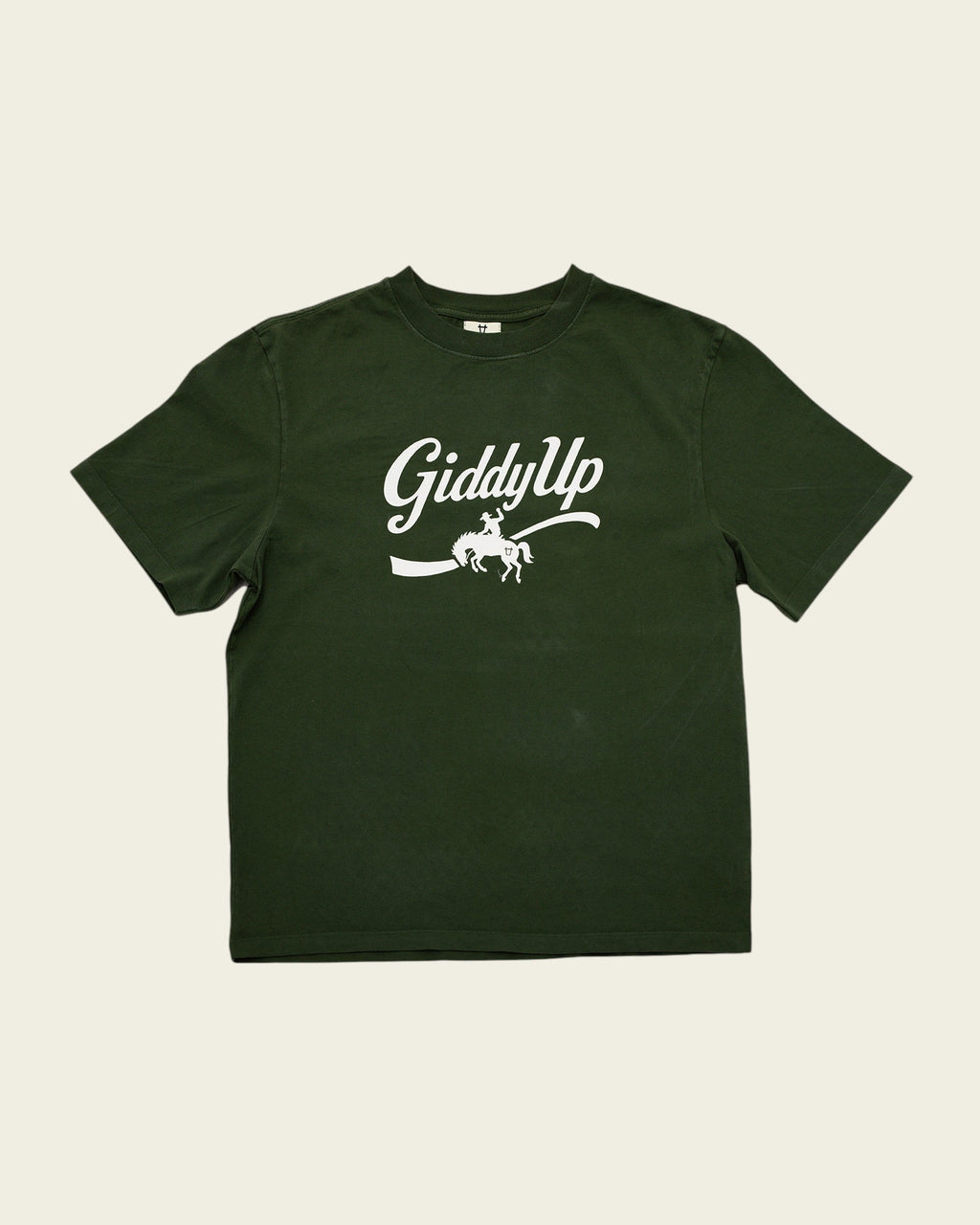 Ayredale Ranch & Co forest green cotton t-shirt featuring a white GiddyUp cowboy graphic on the chest.