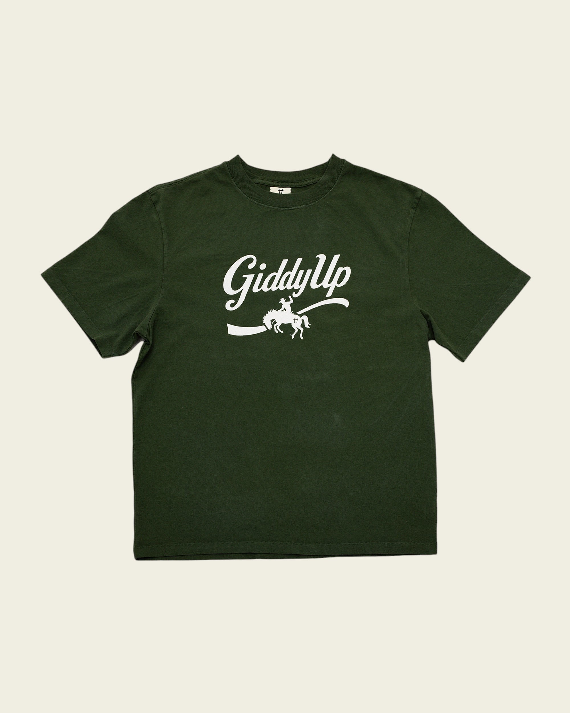 Ayredale Ranch & Co forest green cotton t-shirt featuring a white GiddyUp cowboy graphic on the chest.