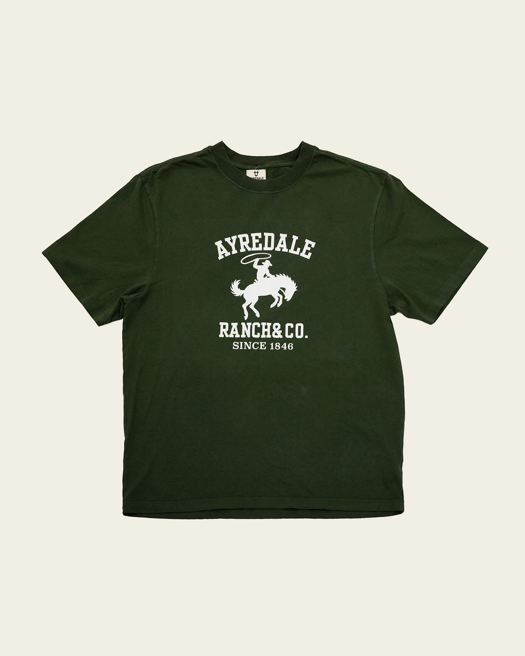 Ayredale Ranch & Co dark green cotton t-shirt featuring a white graphic of a cowboy on a bucking horse.