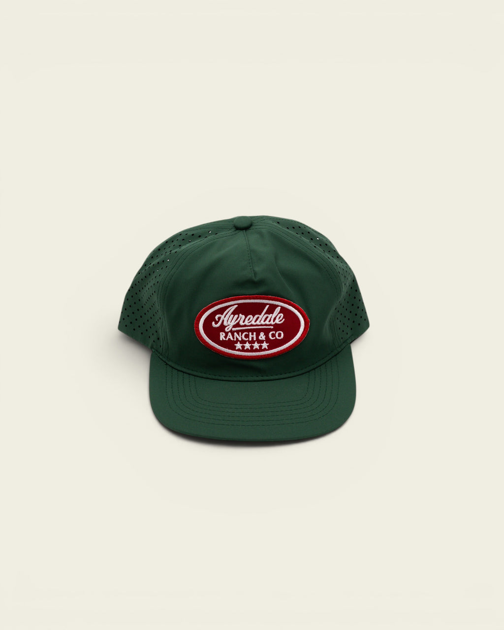 Ayredale Ranch & Co dark green perforated performance baseball cap with a red and white oval logo patch