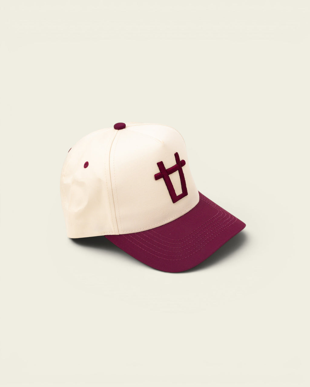 Ayredale Ranch & Co cream baseball cap with maroon brim and embroidered logo on front.