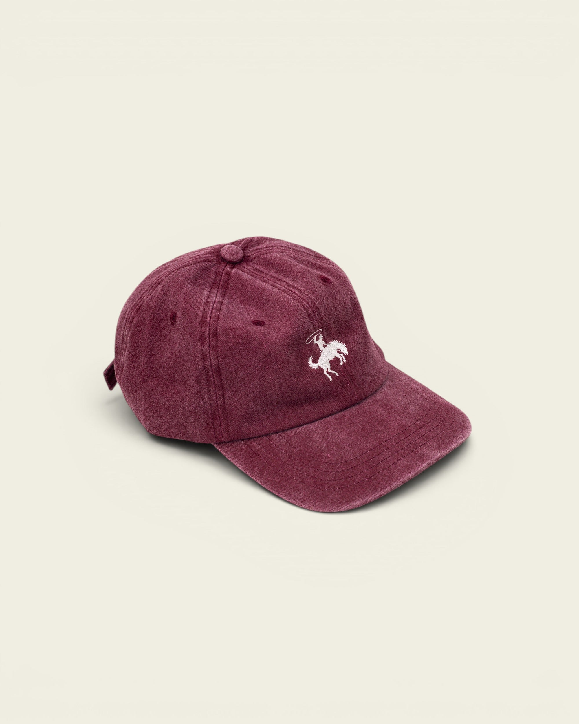 Ayredale Ranch & Co faded maroon washed cotton baseball cap with white embroidered rodeo rider detail.