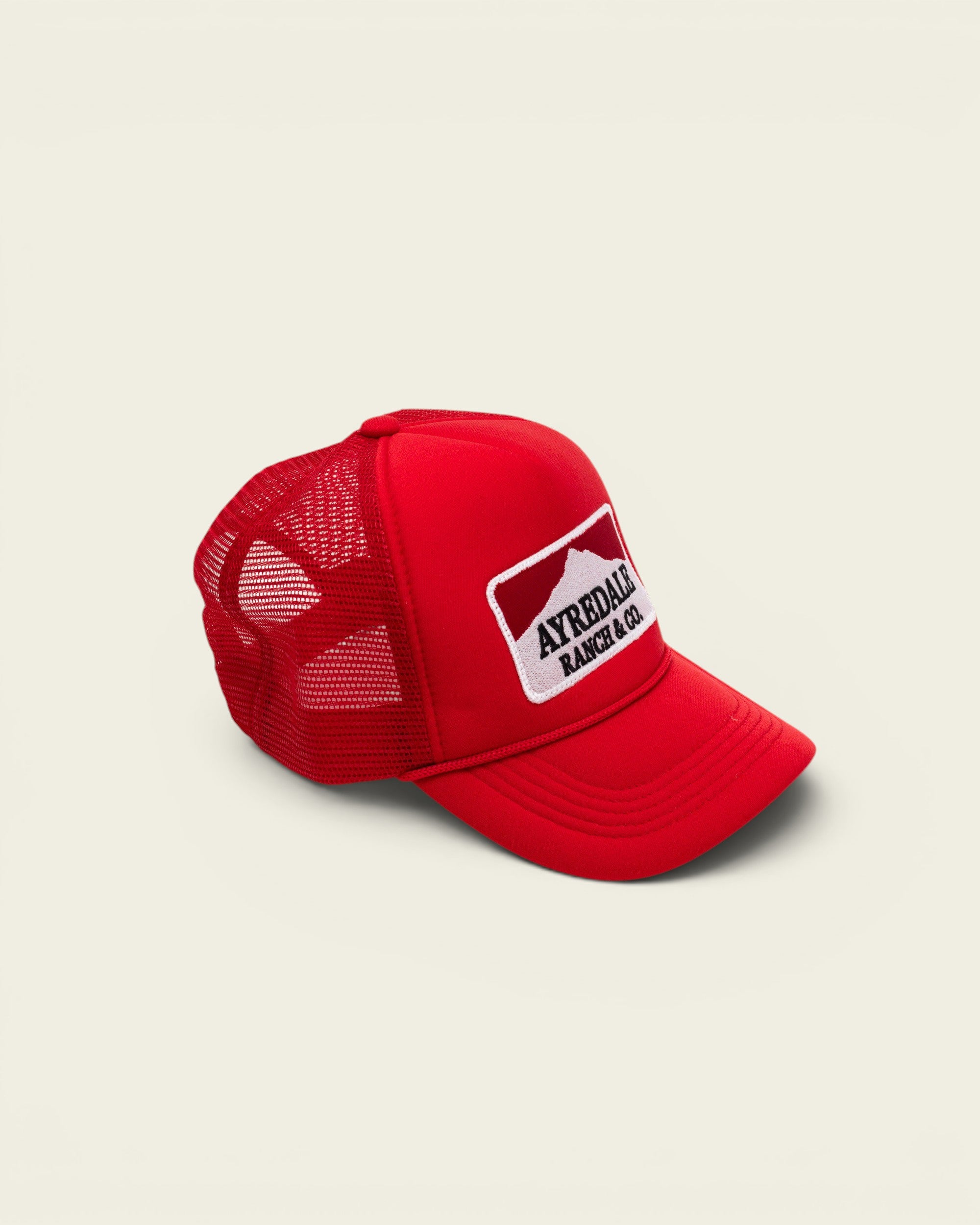 Ayredale Ranch & Co Mount Warning red trucker hat with mesh back and white mountain logo patch
