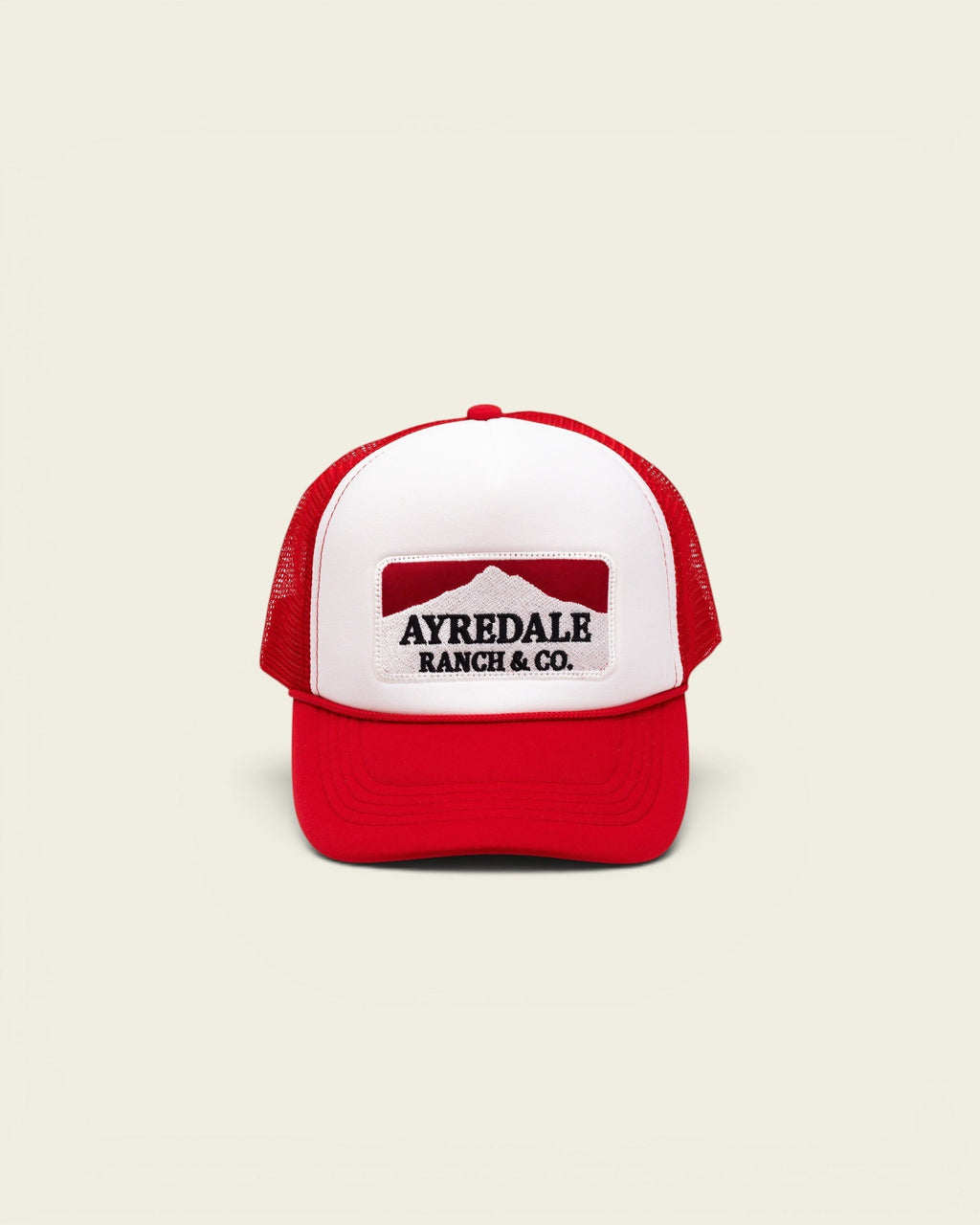 Ayredale Ranch & Co. Mount Warning white and red trucker hat with a mountain graphic patch on the front foam panel.