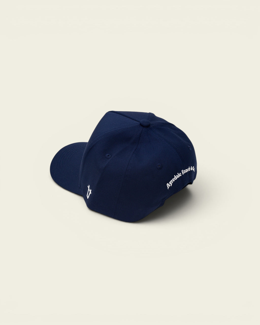 Ayredale Ranch & Co navy blue baseball cap with white embroidered logo on the side and text on the back.