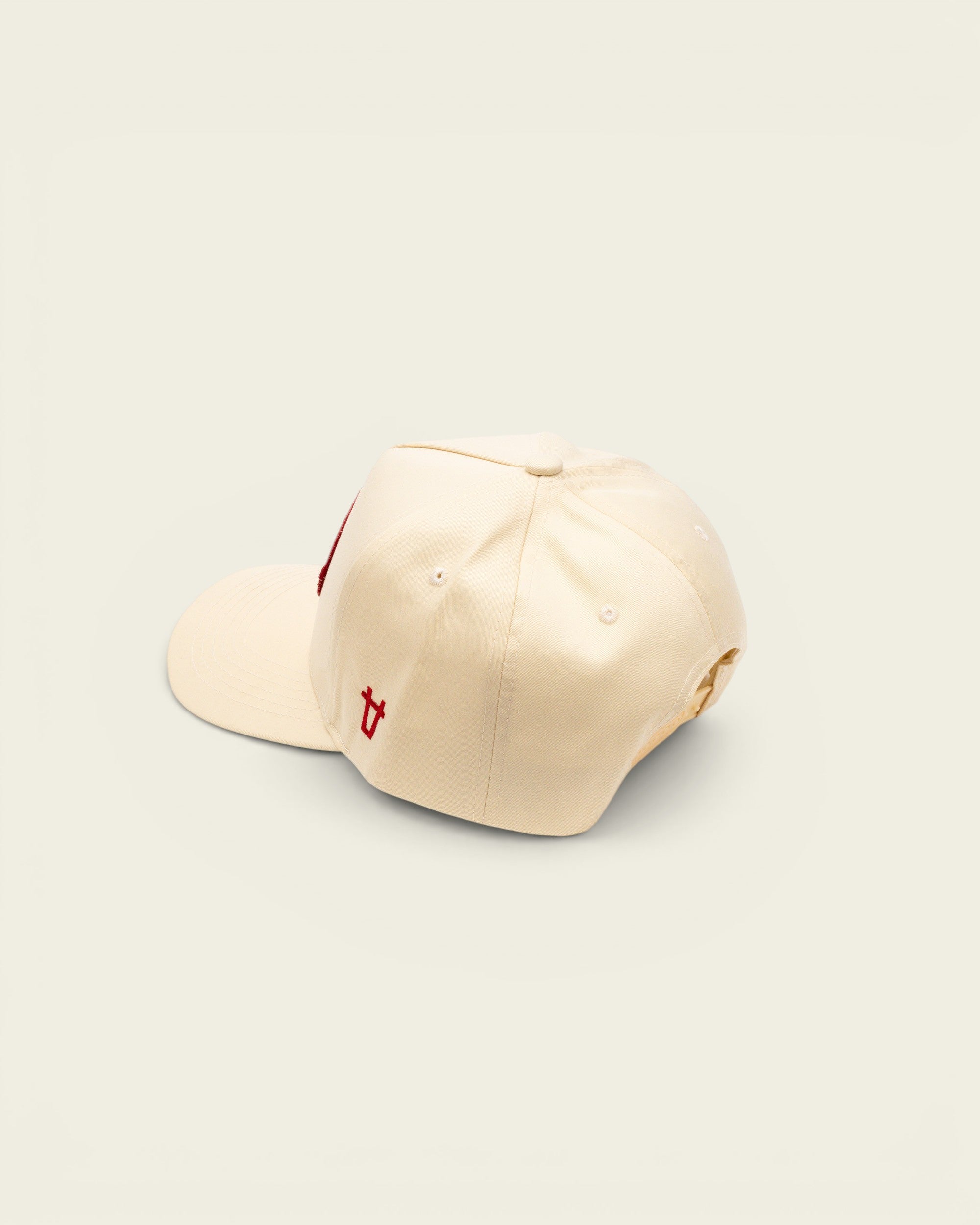 Ayredale Ranch & Co off-white baseball cap with a red embroidered patch and small red logo detail on the side.