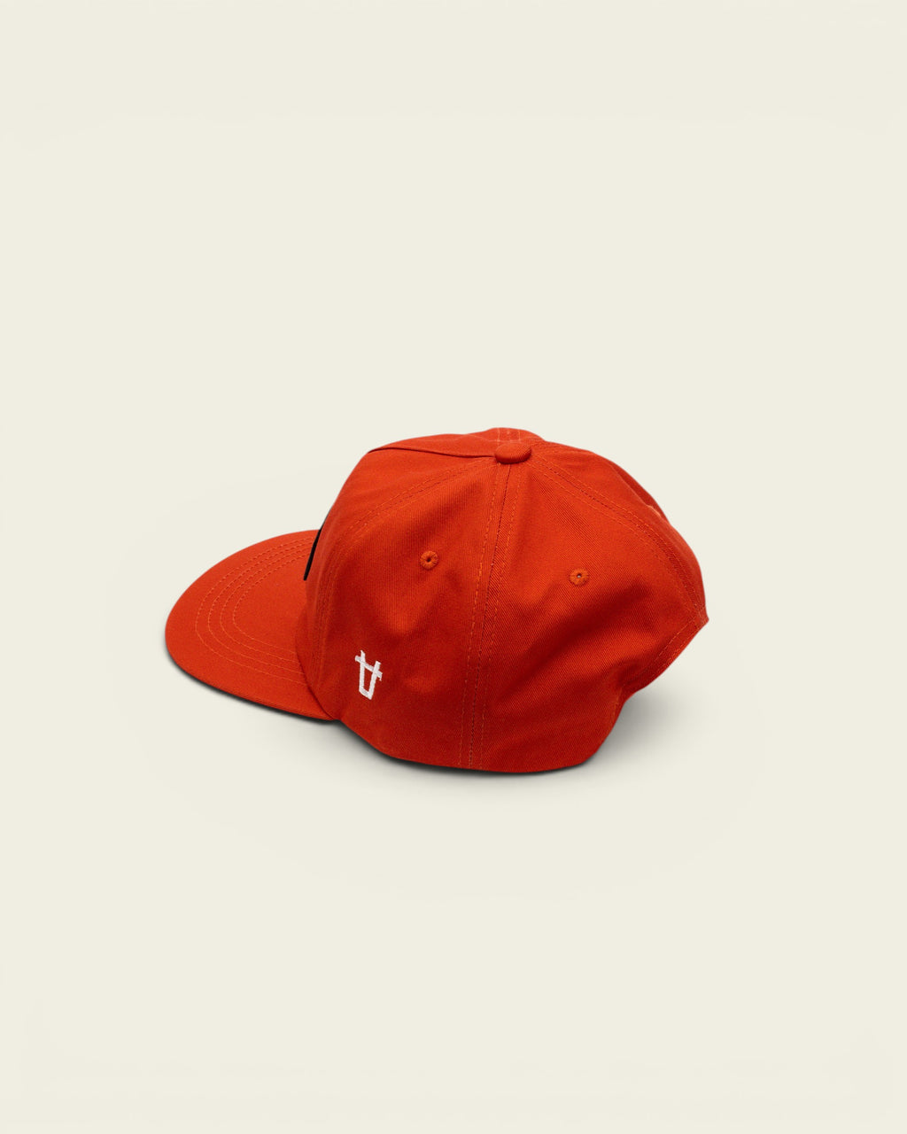 Ayredale Ranch & Co bright orange baseball cap with a black side badge and white embroidered logo detail.
