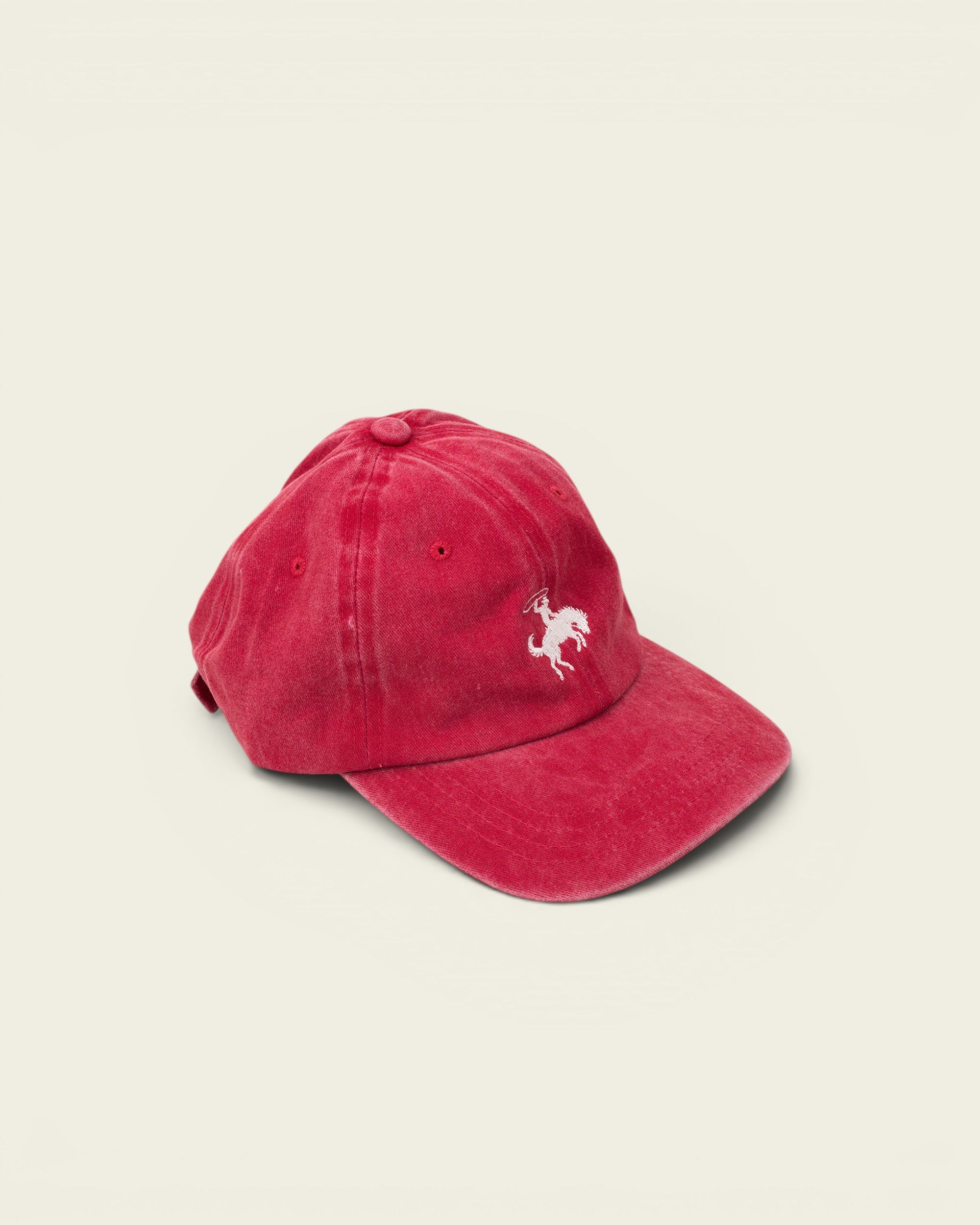 Ayredale Ranch & Co faded red cotton baseball cap with white embroidered rodeo rider detail.