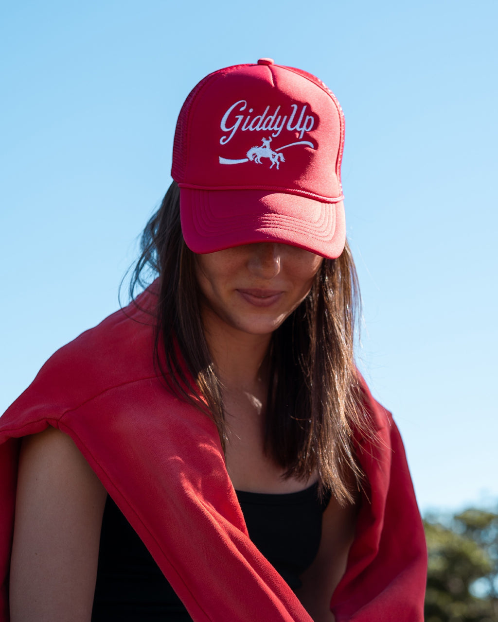 Ayredale Ranch & Co red trucker hat with white "Giddy Up" embroidery and horse graphic