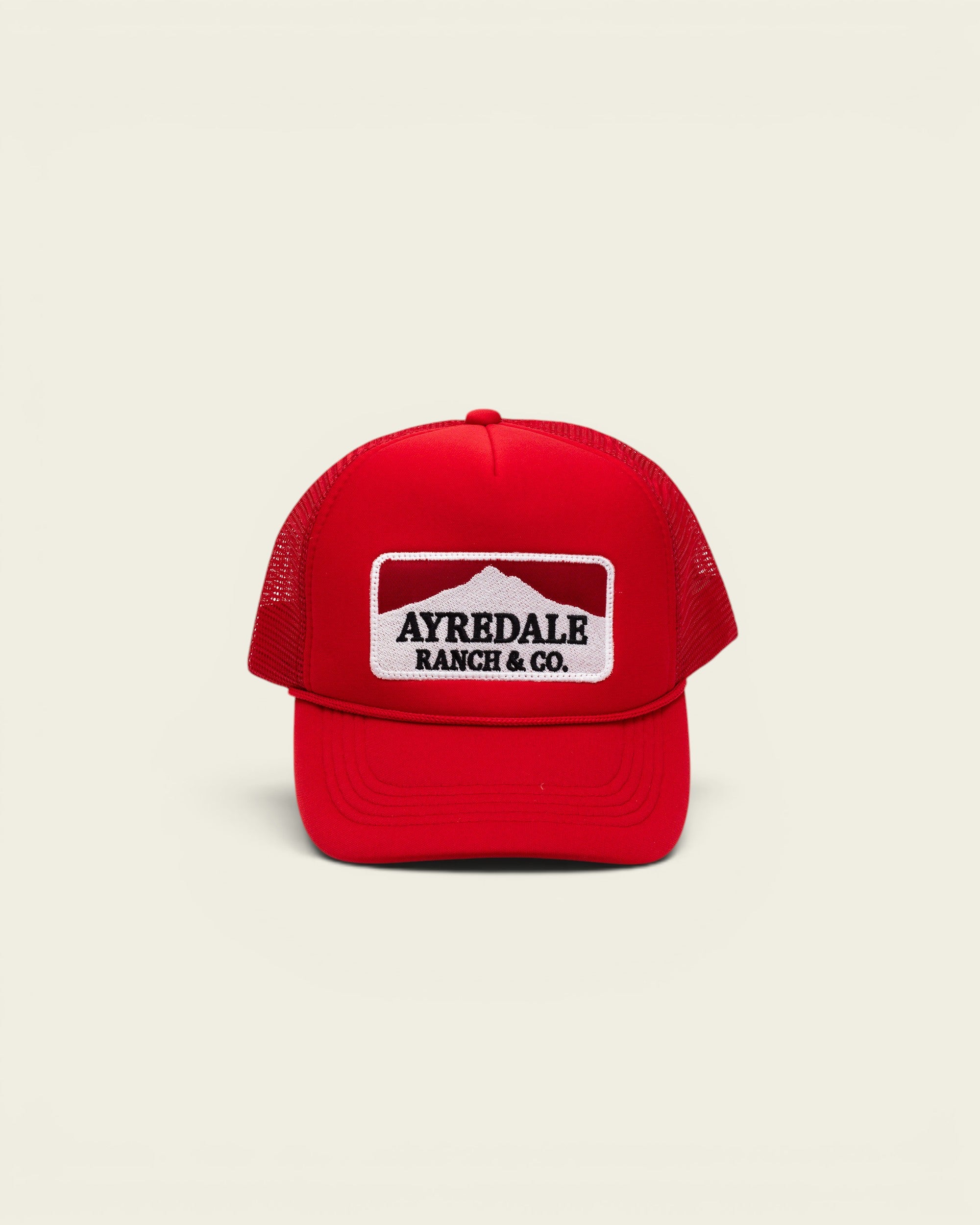 Ayredale Ranch & Co Mount Warning red trucker hat with white mountain logo patch and breathable mesh back