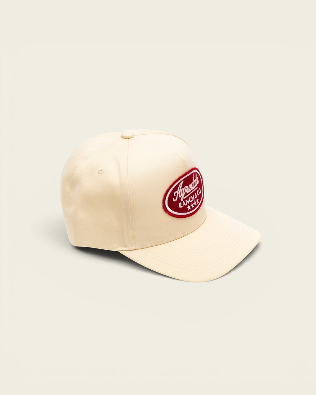 Ayredale Ranch & Co off-white baseball cap featuring a red oval patch with white embroidered logo and four stars